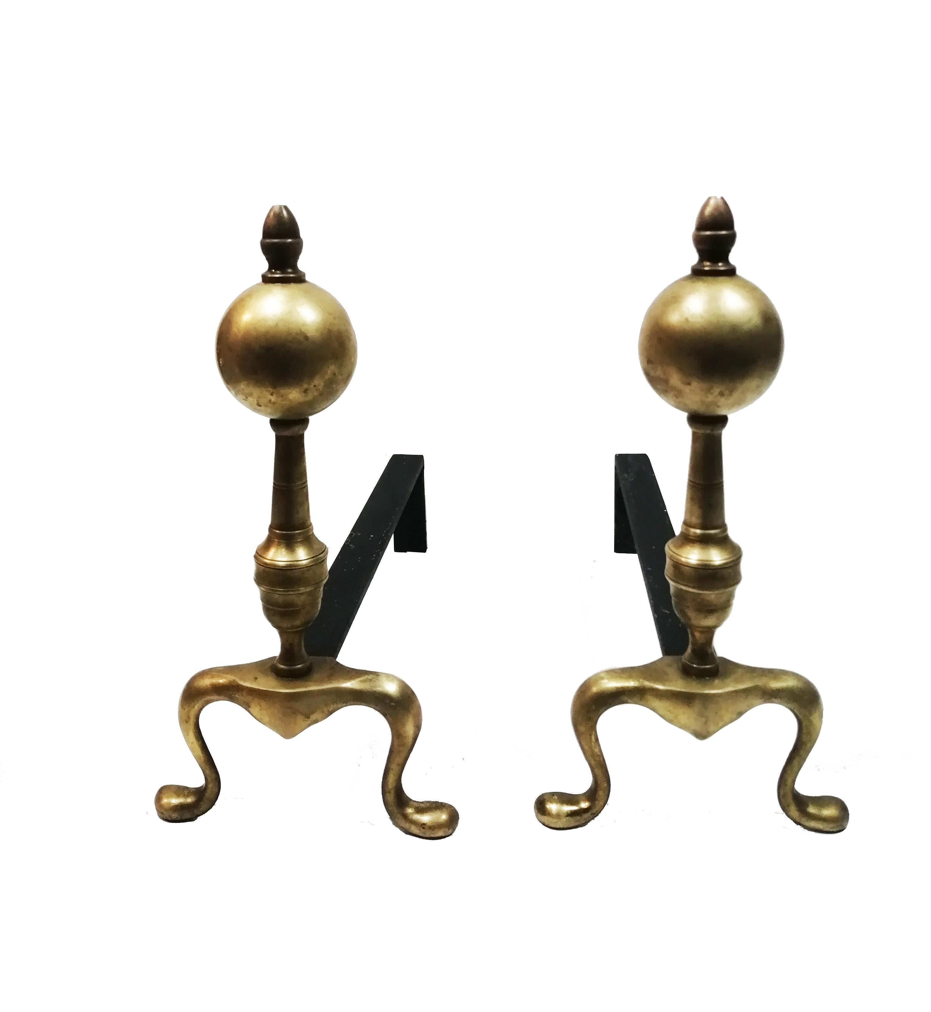 A pair of English brass and iron andirons, from the first half of the 20th century.

  