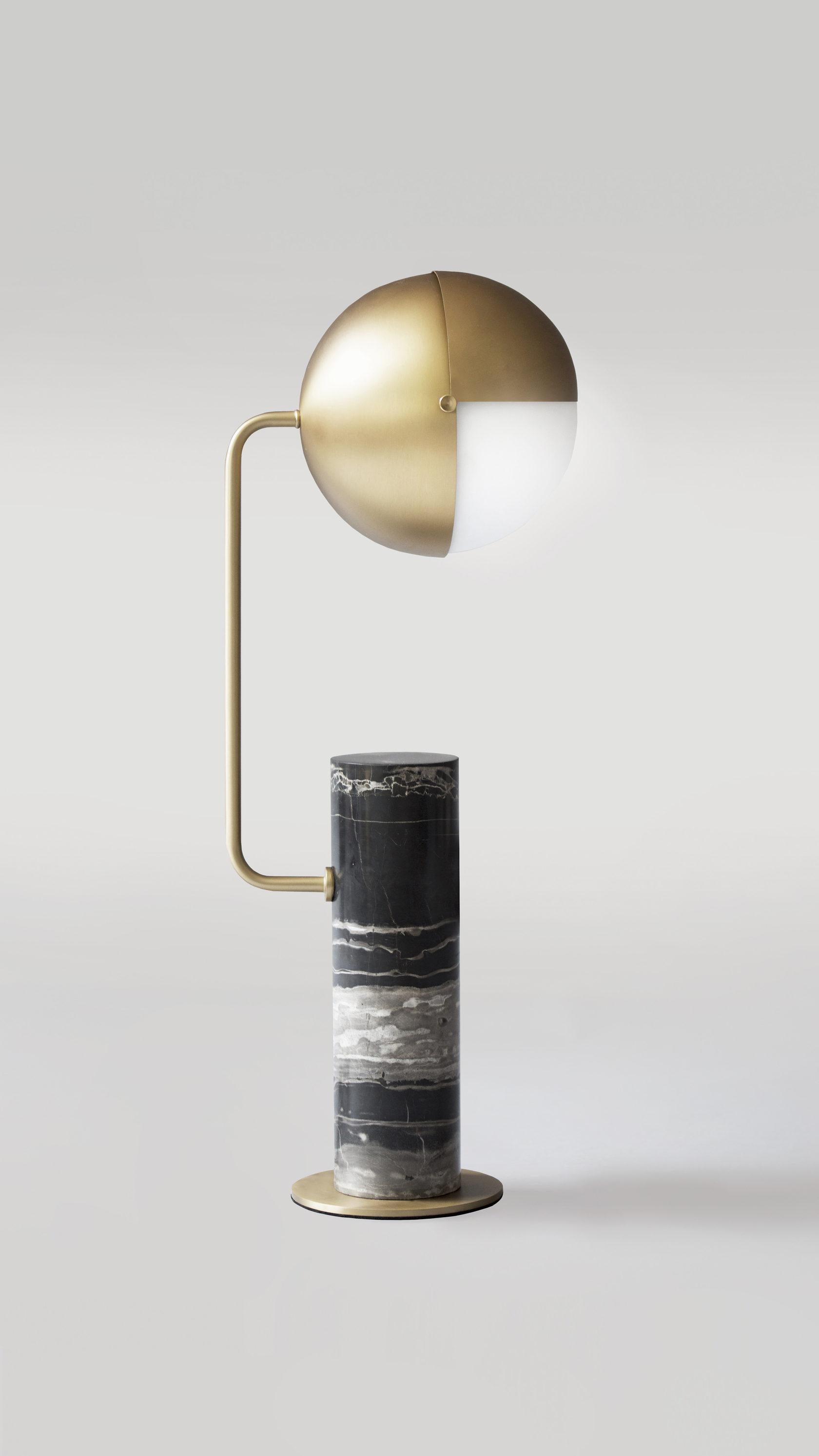 Brass Another Table Lamp by Square in Circle
Dimensions: H 60 x W 25.6 x 25.6 cm.
Materials: brushed brass finish, frosted glass, black marble base. 

A marble base table lamp with a rounded projecting arm to one side, topped with an unusual metal