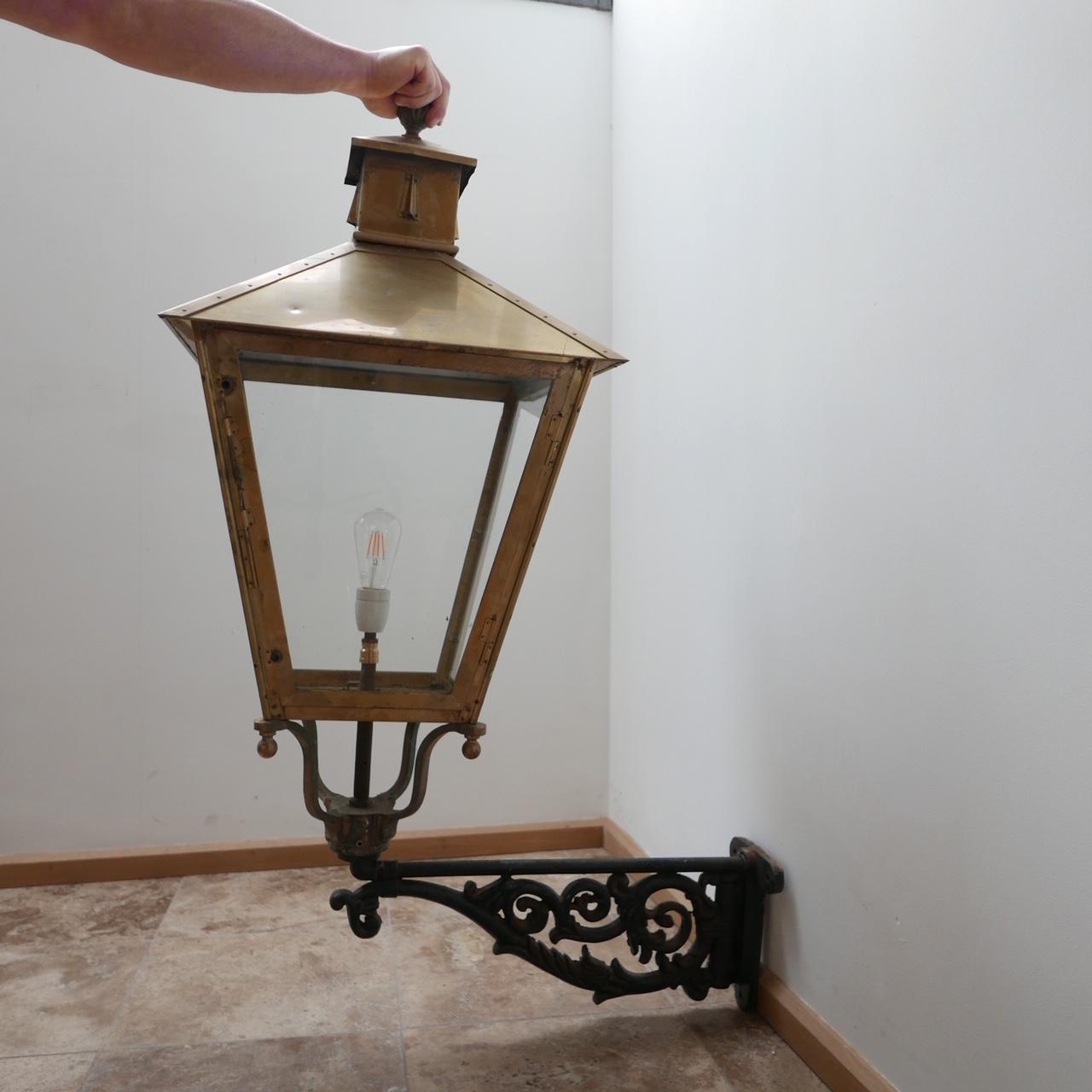 A large pair of brass and cast iron wall lanterns.

Originally used as street lights in The Hague.

Holland, early 20th century.

Price is for the pair.

Re-wired and PAT tested.

Dimensions: 140 H x 85 D x 52 W in cm.

   