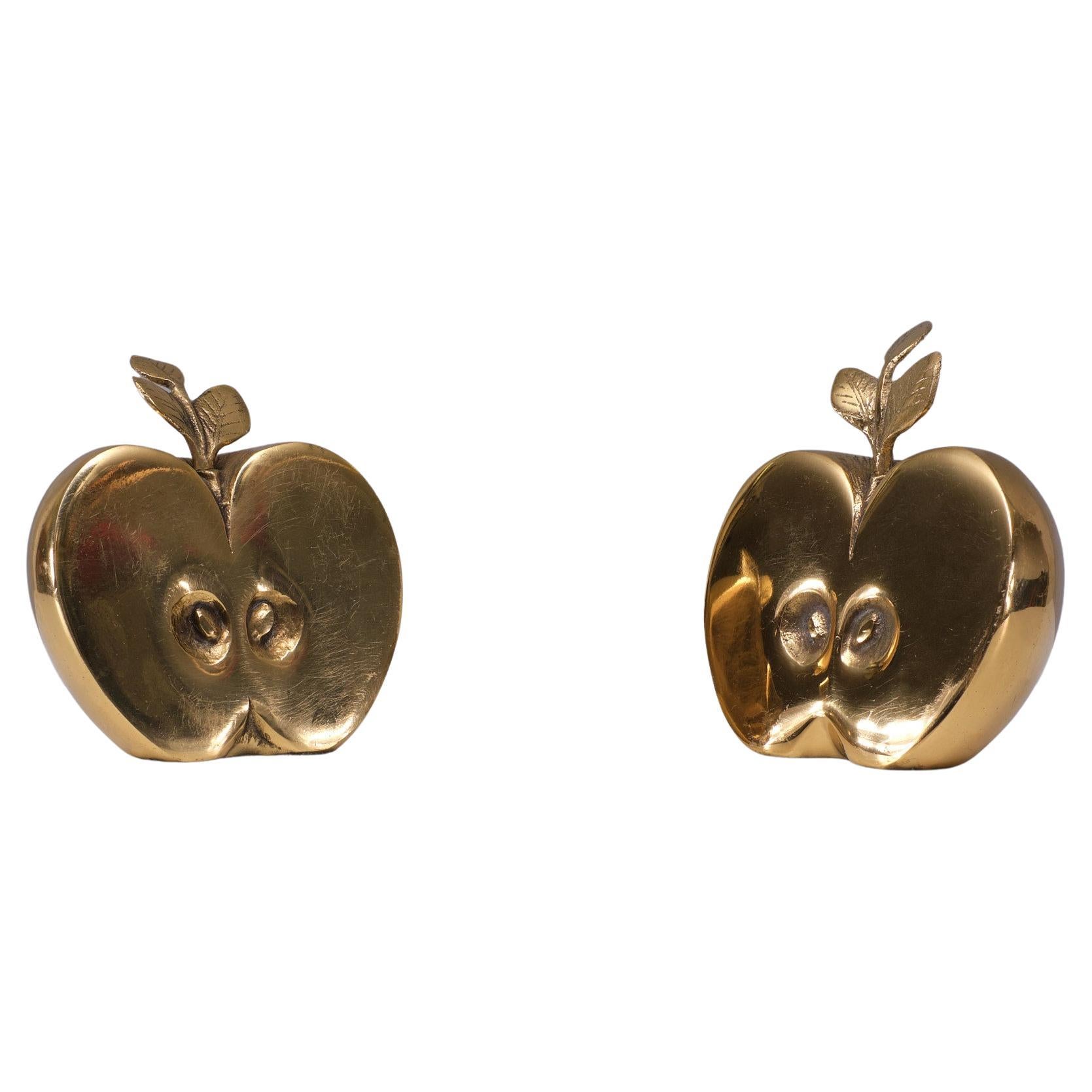 Beautiful set of two 1970s Hollywood Regency Dutch Apko  shiny brass apple parts to use as bookend, decoration or paperweight.  signed Apko .  the price = set price 
