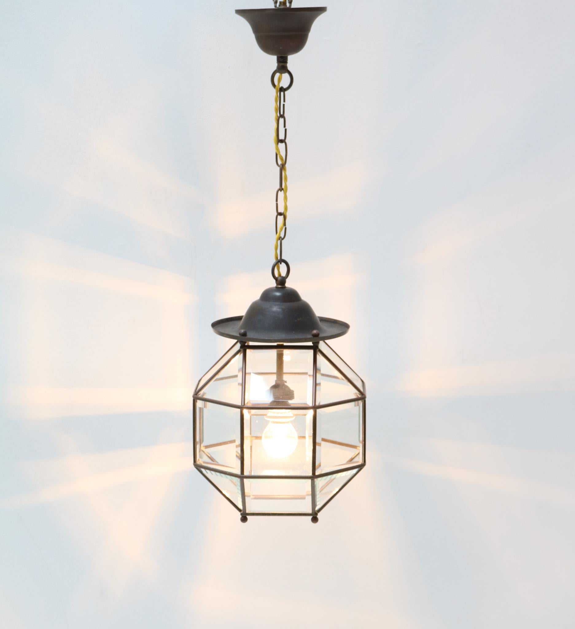 Stunning Art Deco lantern.
Striking Dutch design from the 1920s.
Patinated brass frame with original beveled glass.
Rewired with one socket for E-27 light bulb.
In very good condition with a beautiful patina.