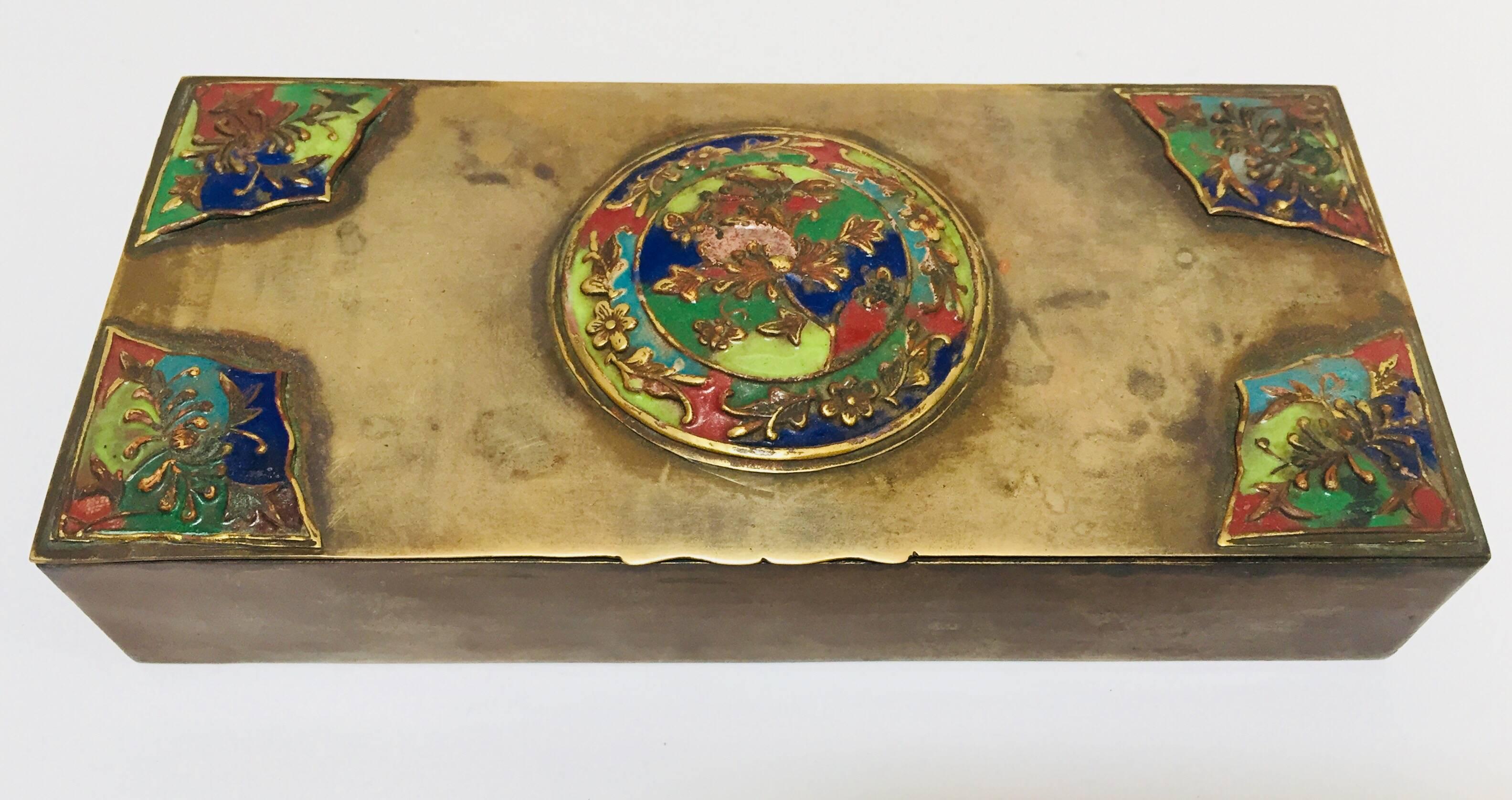 handcrafted brass Art Deco lidded box with enameled decoration.
Vintage decorative metal Mid-Century Modern brass lidded box trinket.
Perfect example of Art Deco charm, an exquisite brass hinged box. 
The box features made from brass, and enamel,
