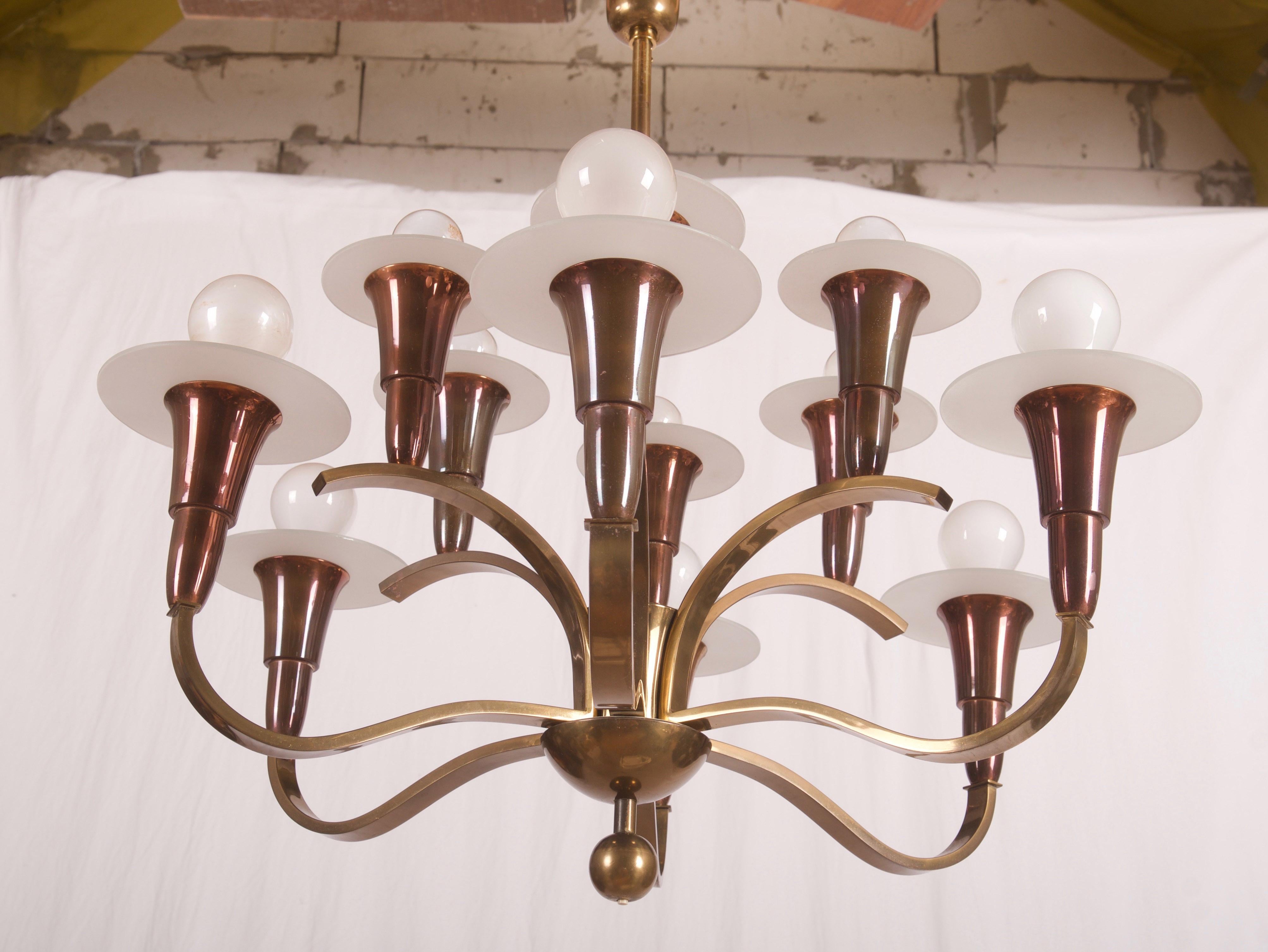 Brass construction with 12 arms fitted with E27 sockets, frosted glass shades.
Manufactured in the 1930s in Germany.
Original used condition with some patina on the steel parts.