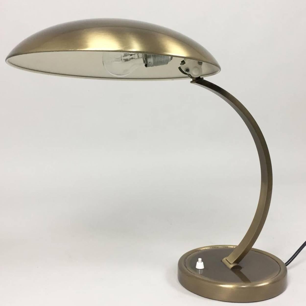 This beautiful patinated brass table lamp was designed by Christian Dell and was produced by Kaiser Idell in the 1950s. Both arm and shade are adjustable.

Industrial designer, silversmith, and teacher Christian Dell was born in 1893 in Offenbach,