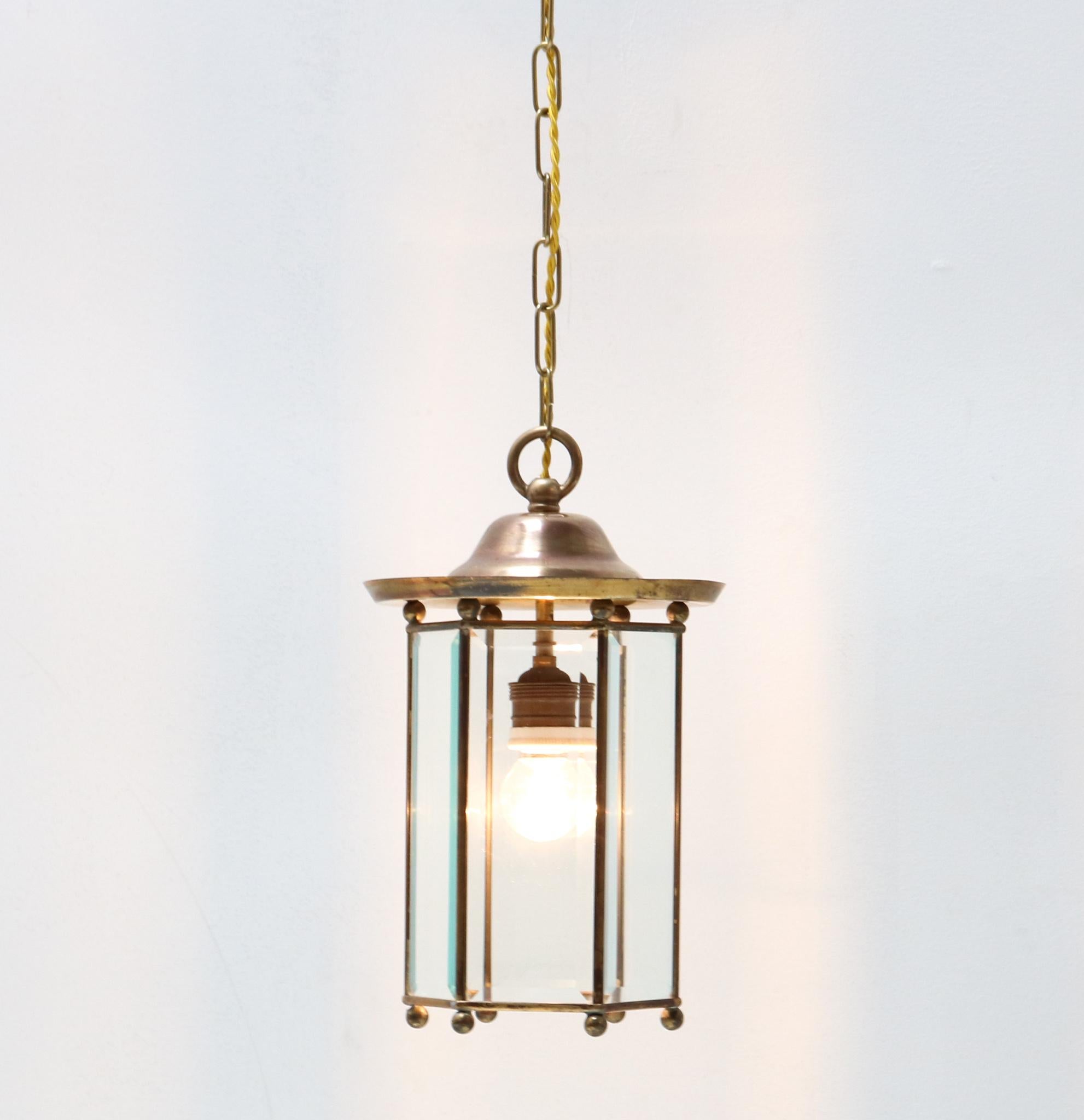 Stunning Art Nouveau lantern.
Striking Dutch design from the 1900s.
Brass frame with original glass.
Rewired with one socket for E-27 light bulb.
In very good condition with a beautiful patina.