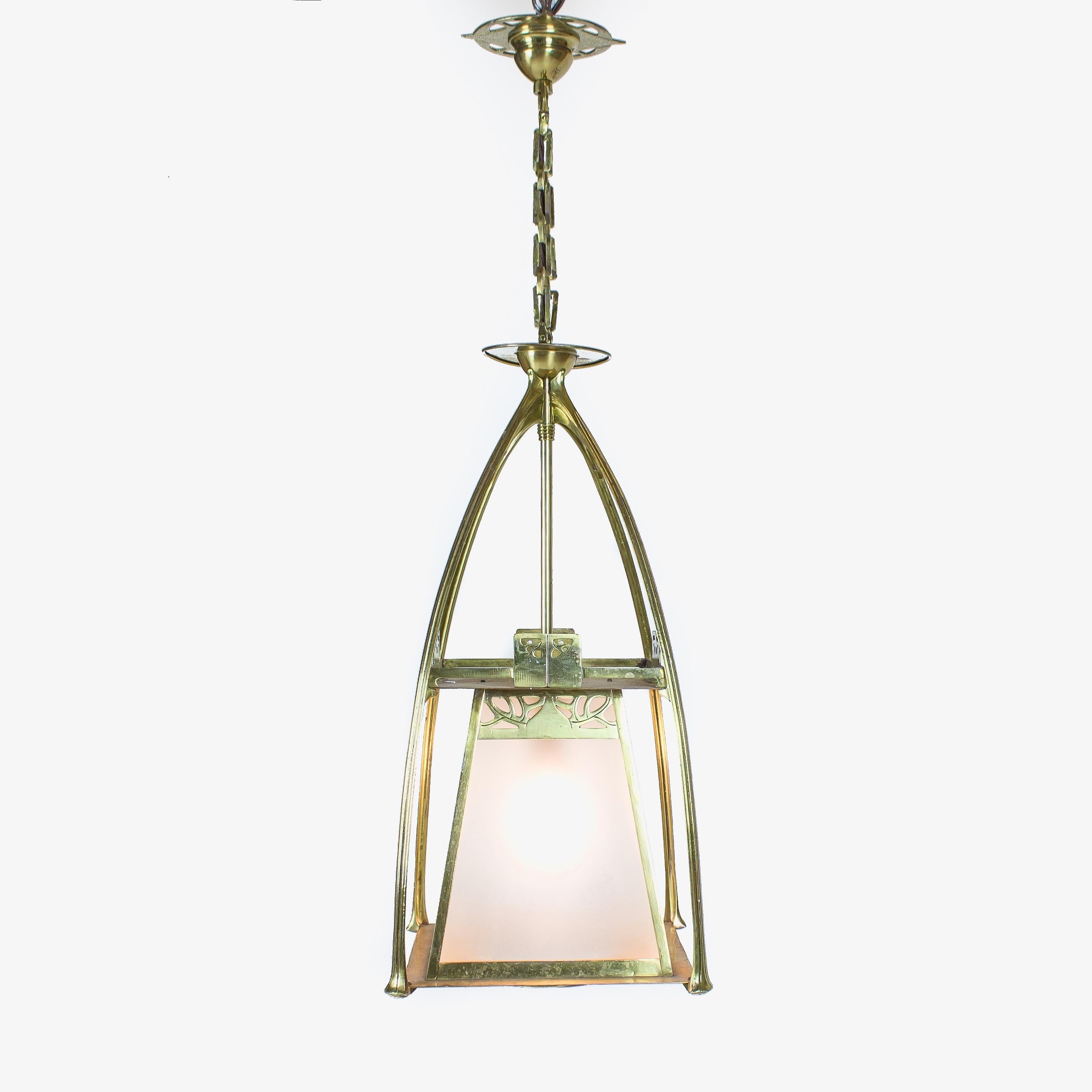 The splayed square section glazed body suspended in four arched uprights.

Probably Belgium, circa 1870s

Height including chain and ceiling rose is 91cm.