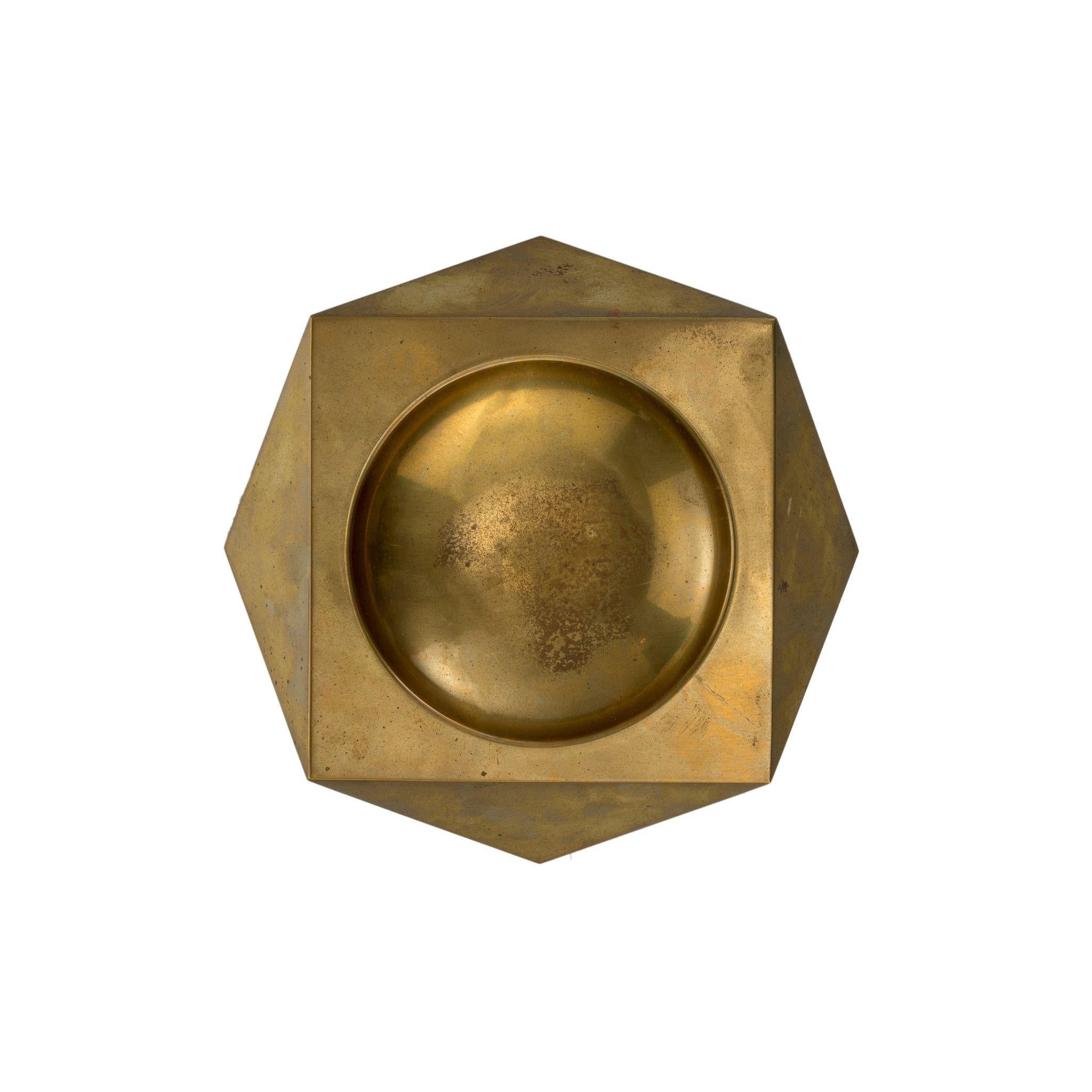 Perfect for both smokers and non-smokers alike, this brass ashtray is not only functional but also visually appealing. Its geometric shape adds a touch of modern elegance to any room, and its durable brass construction ensures it will stand the test