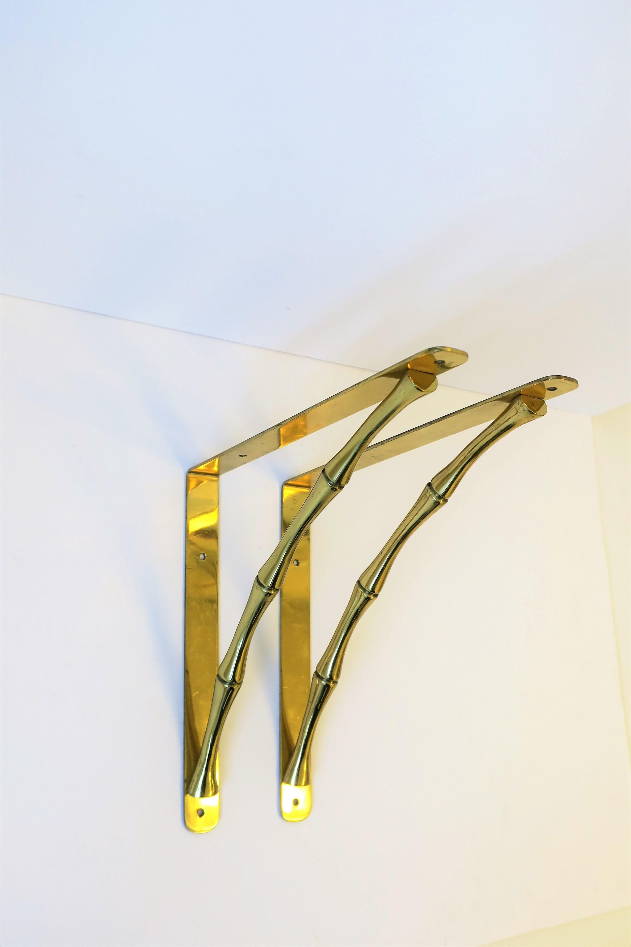 A beautiful pair of substantial brass hardware wall shelf brackets with bamboo design, circa mid-20th century. Brackets are a nice size measuring 10.75 inch deep from wall or, alternatively, 9.75 inches deep from wall - all depends on which side you