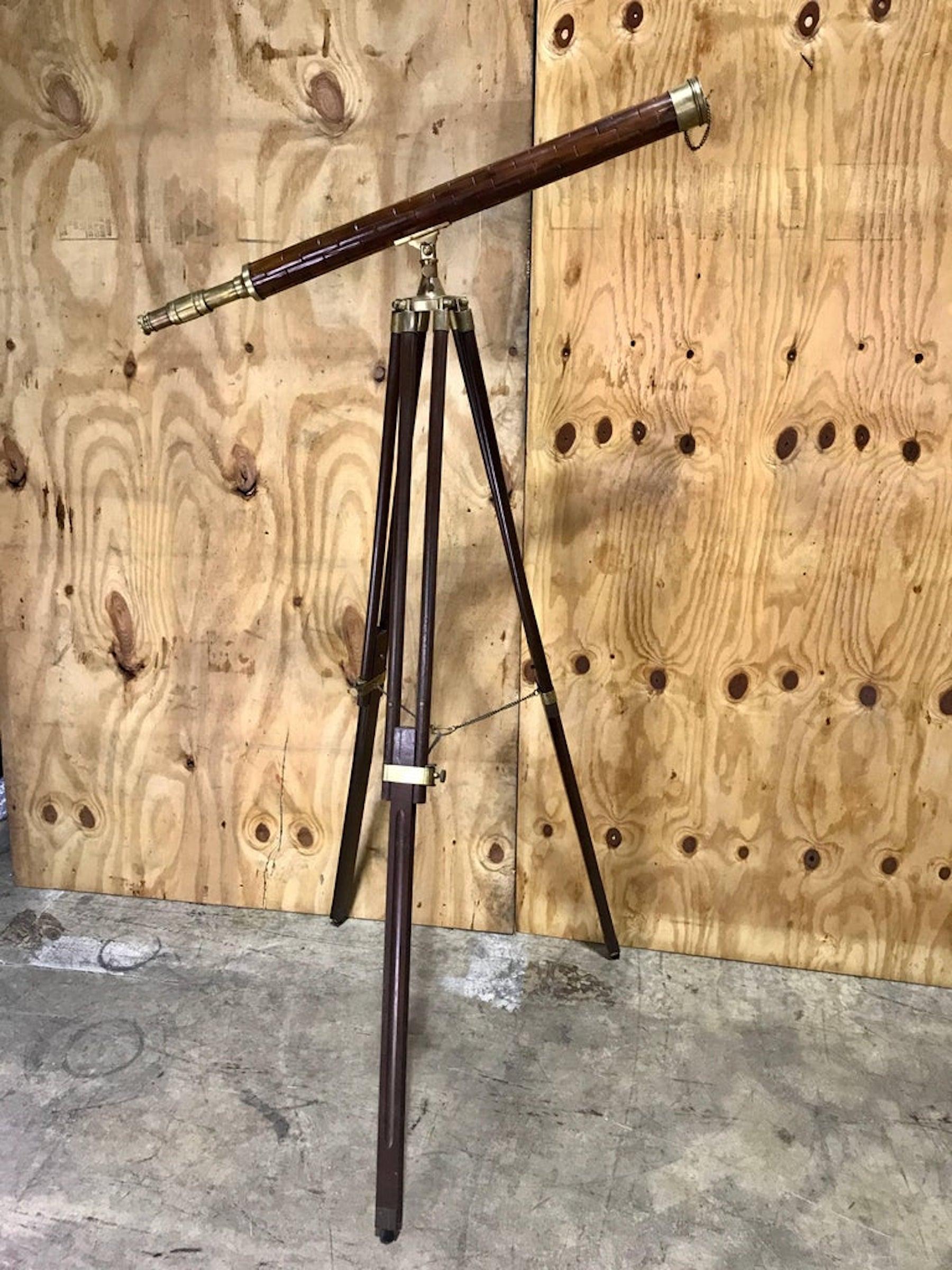 Brass and bamboo telescope and stand, the brass mounted shingled telescope fitted raised on adjustable tripod base. Two pieces
As shown assembled 65