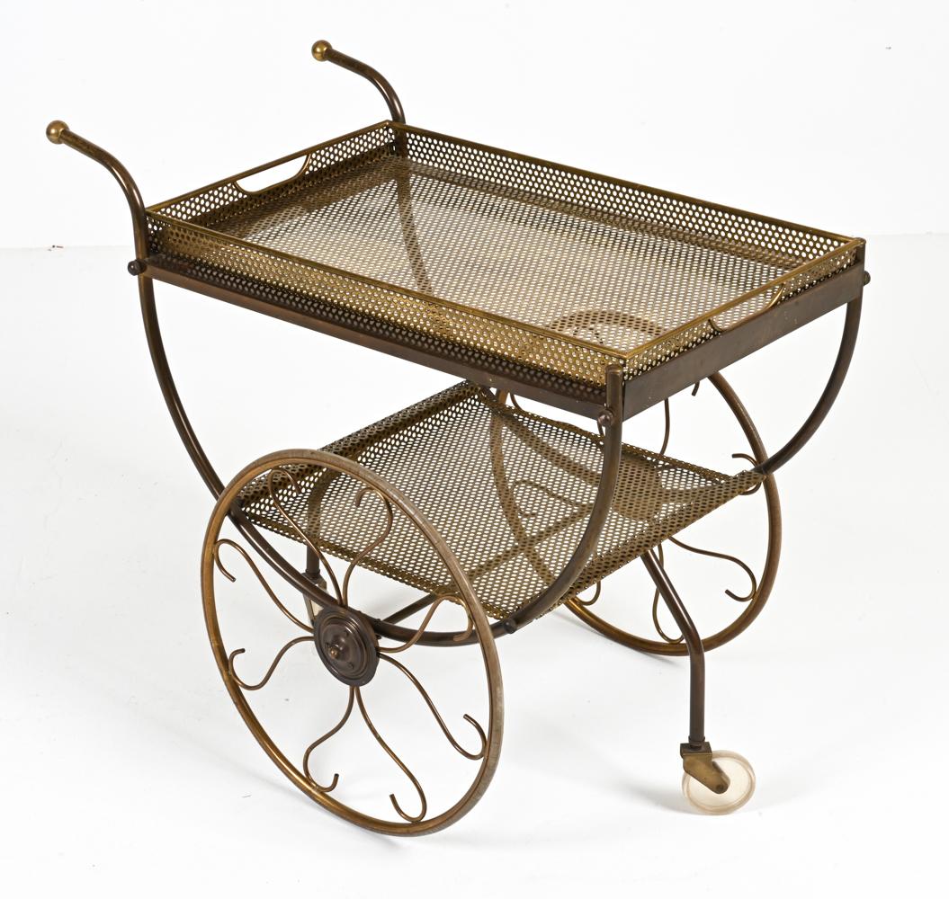 Channel Old Hollywood glamour with this fantastic and rare serving trolley designed by Josef Frank for Svenskt Tenn. Crafted from pierced brass with scrolled wirework decorating its dramatically oversized back wheels, this cart casts a mesmerizing