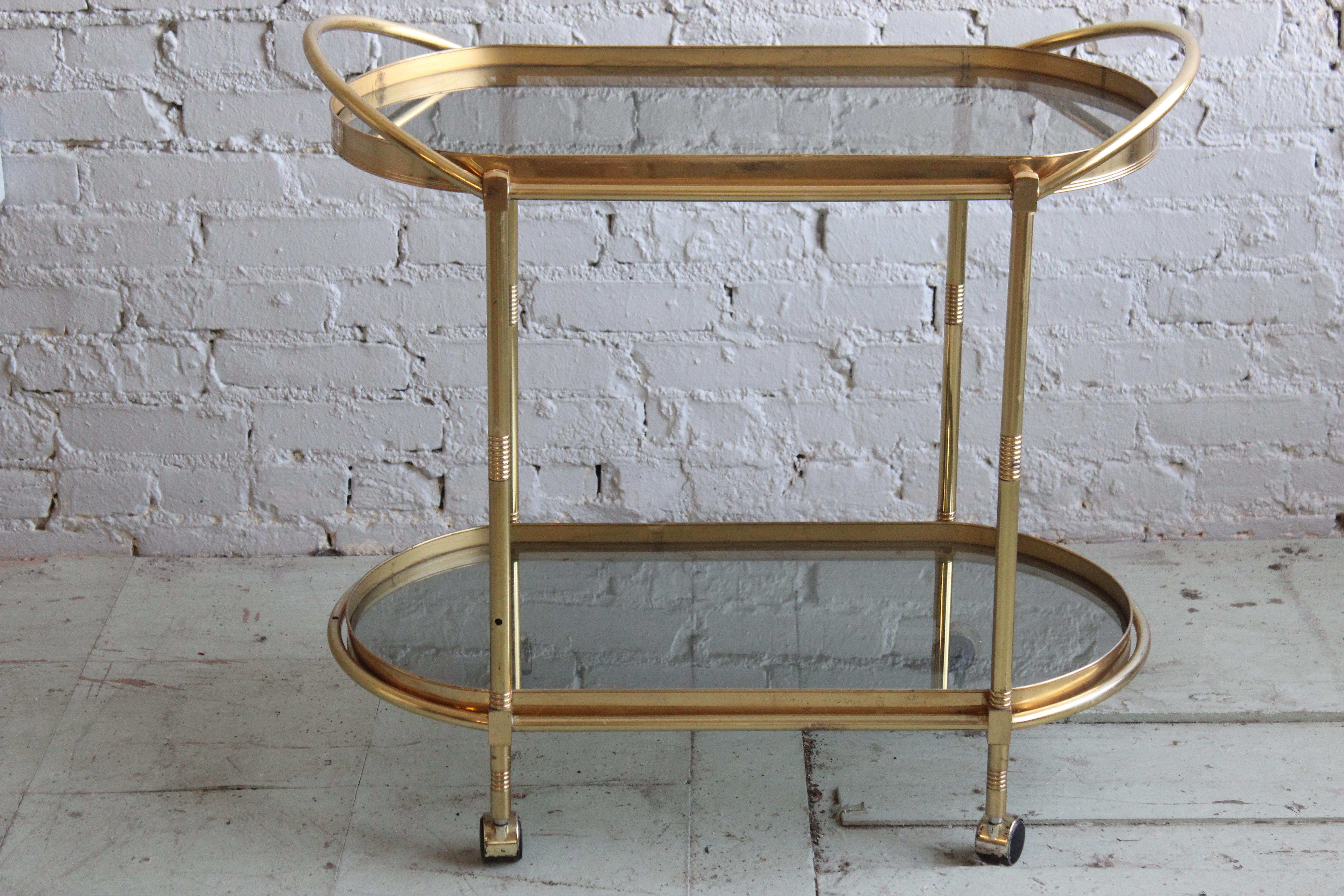 Two-tier brass bar cart. The glass tray is removable.
