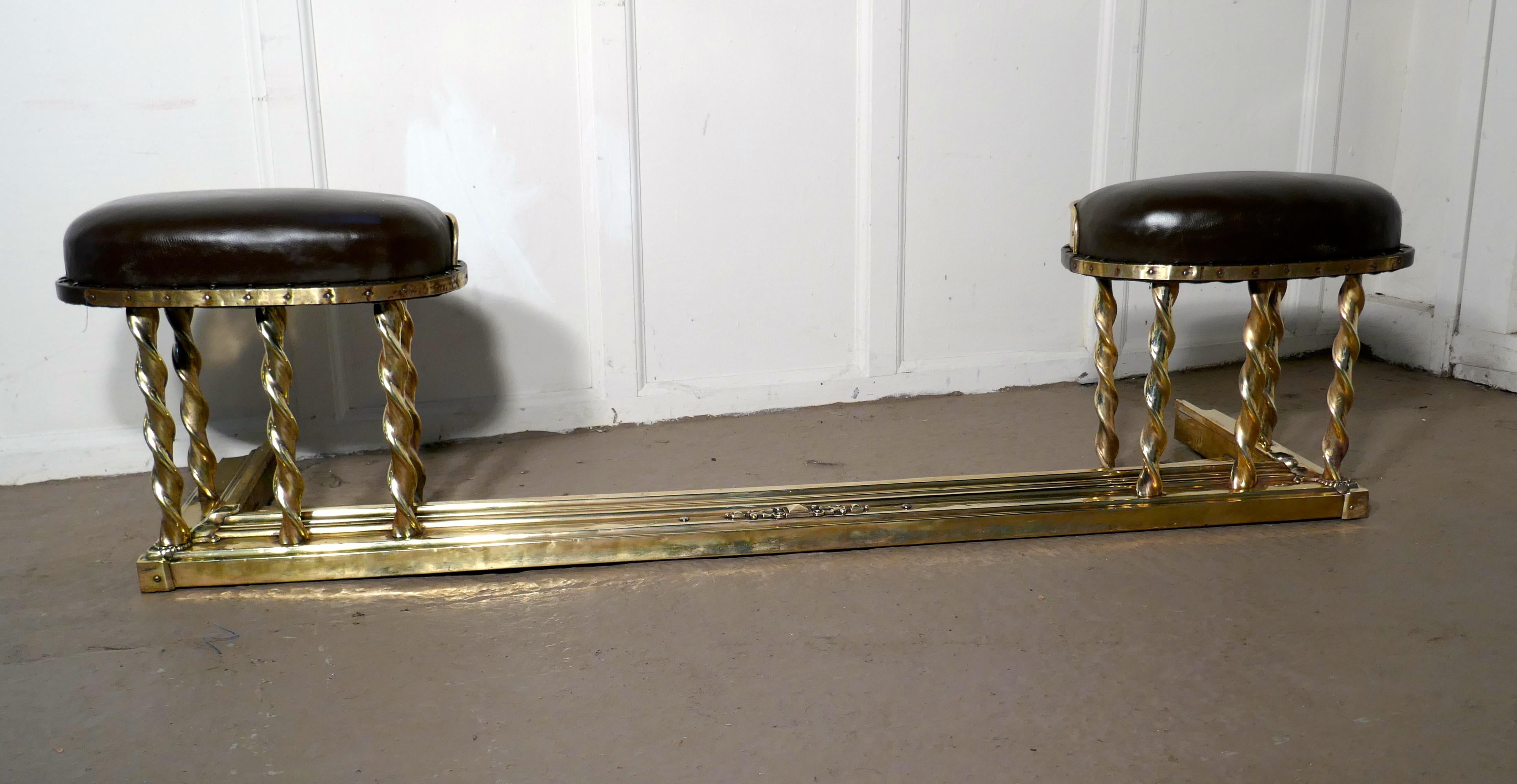 Brass Barley twist club fender

This is an elegant and very unusual piece of country House Furniture, the fender has brass studded brown leather upholstered seats, these a supported on barley twist brass columns
The fender has an embossed