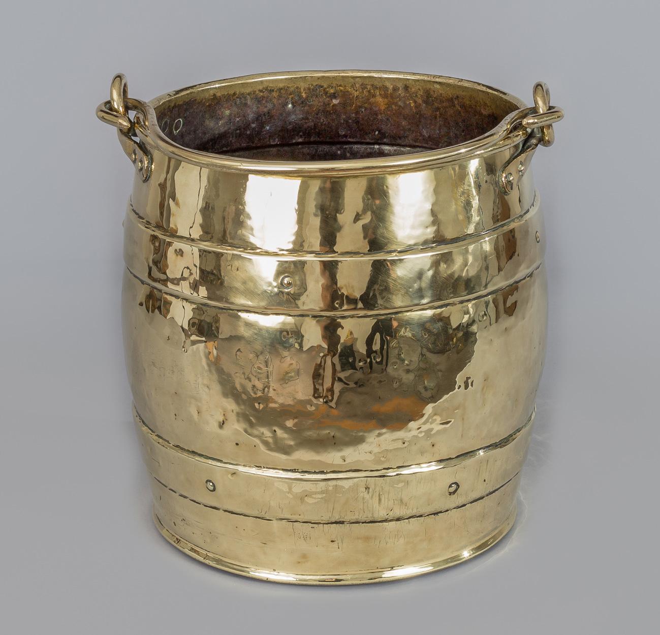 Brass barrel-shaped coal with brass handle.