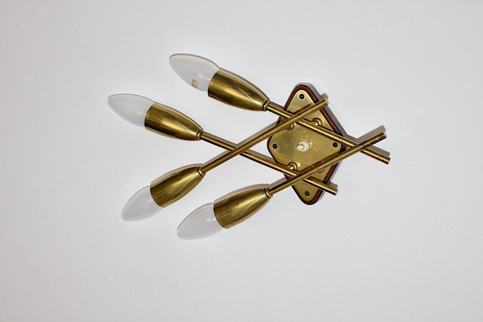 Brass sconce or wall light by Rupert Nikoll, which was designed and manufactured 1950s Vienna, Austria.
A beech base in contrast with 4 brass constructed E 14 sockets forms a beautiful sconce from the Mid-Century Modern era
and results in an