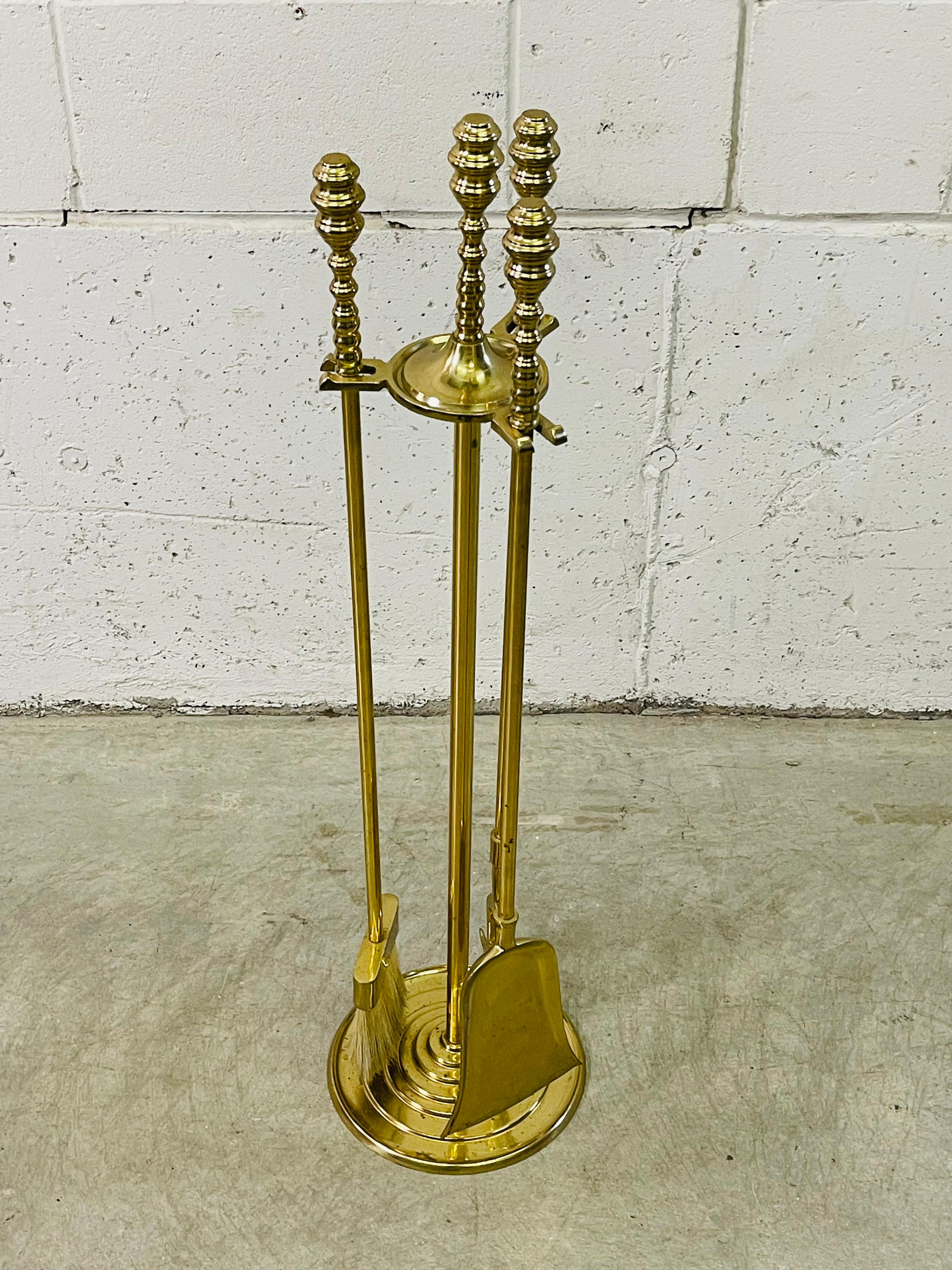 Vintage solid brass beehive style set of four fireplace tools. The handles have the beehive styling and it comes with three tools and the holder. The set is solid and sturdy.