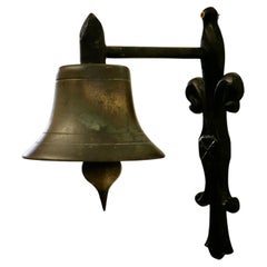 Antique Brass Bell on a Cast Iron Bracket