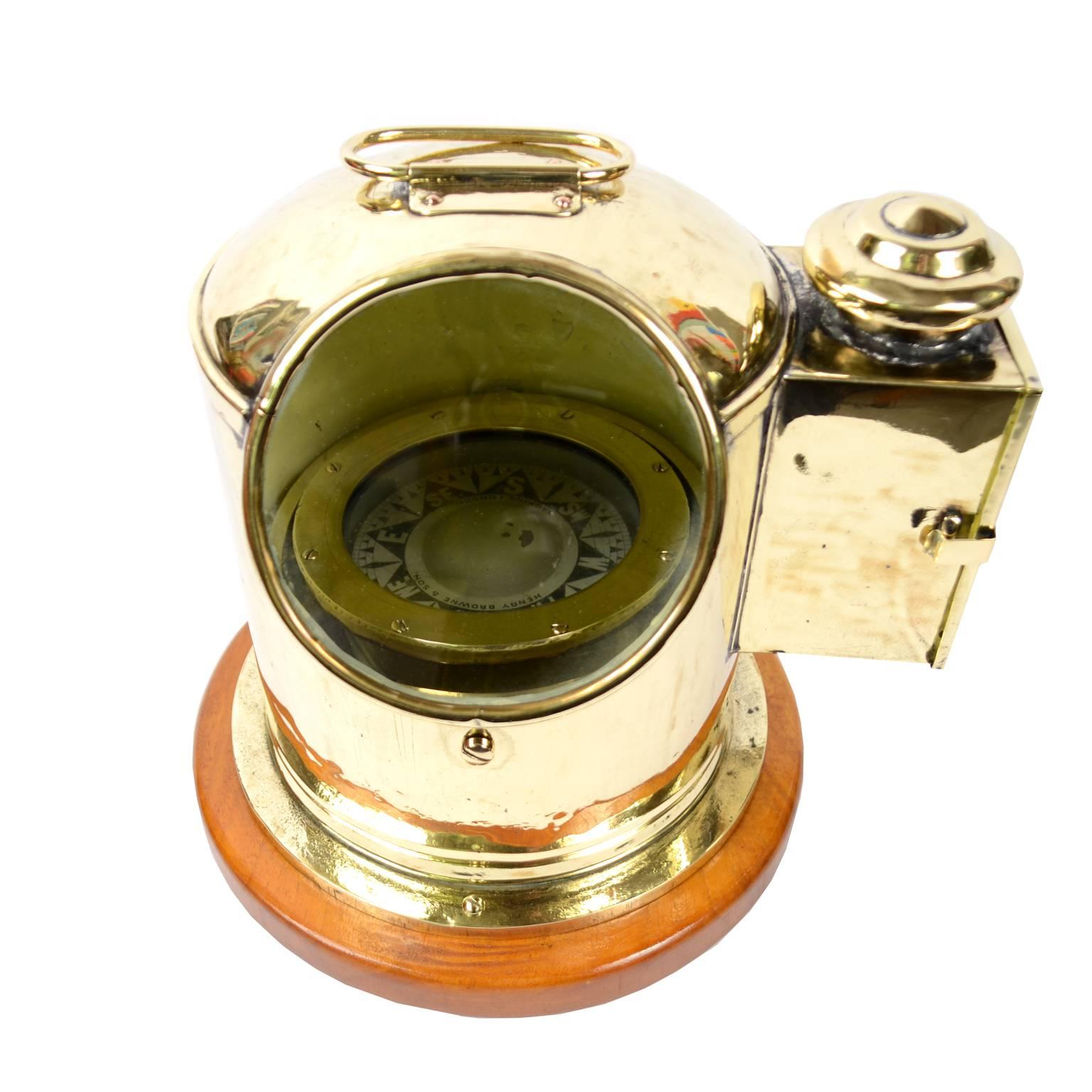 Liquid compass mounted on universal joint made in 1920s. It's a magnetic compass with gimbals, mounted in a lifeboat binnacle, brass and glass, with light for night illumination. Measures: Height cm 26 - inches 10.23. Shipping insured by Lloyd's