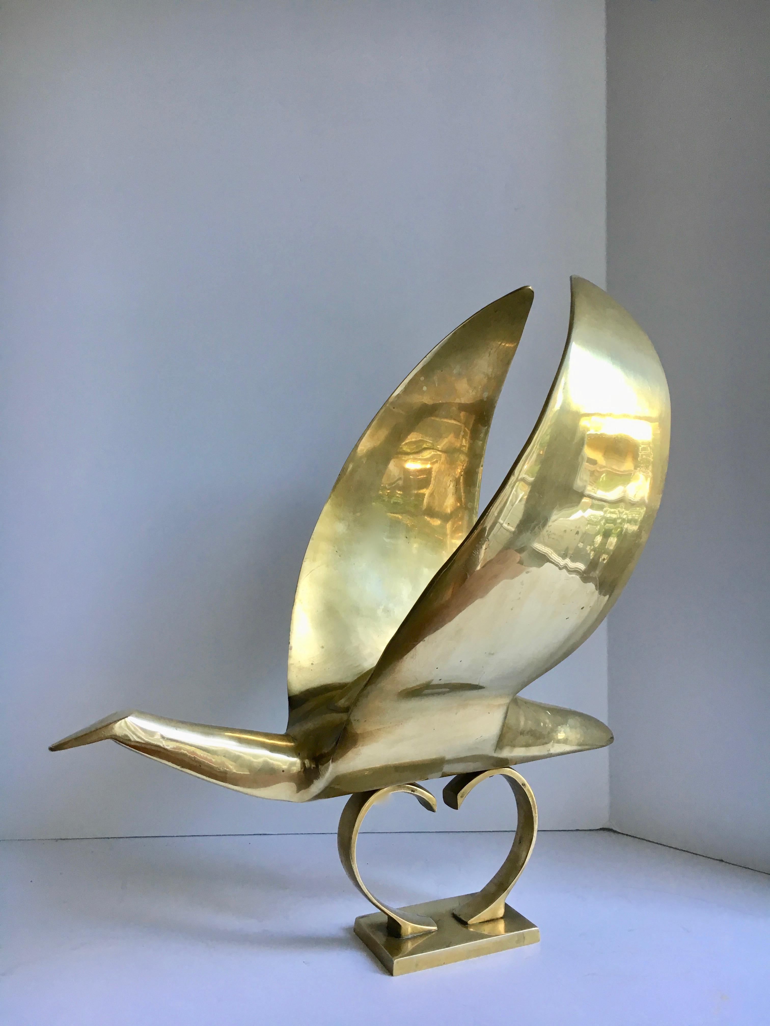 Brass bird sculpture hood ornament - a beauty, this large and impressively architectural sculpture / hood ornament represents a graceful and bold bird in flight.

The piece alone can be a dynamic sculpture - on the practical side a great paper