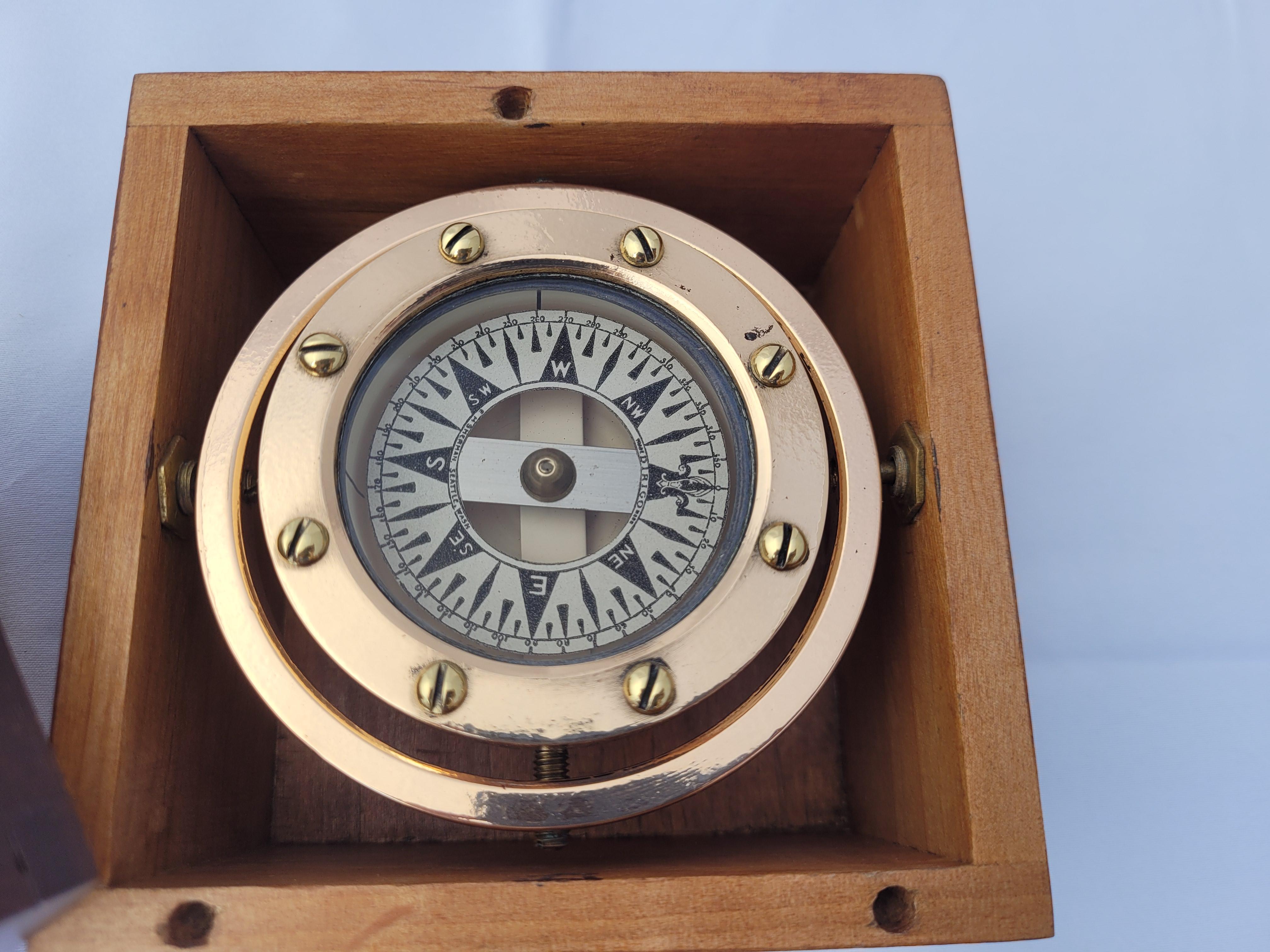Classic early twentieth century boat compass by Dirigo of Seattle Washington. The entire gimballed compass has been meticulously polished and lacquered. This Classic marine instrument is fitted to its original hardwood box with a fine varnished