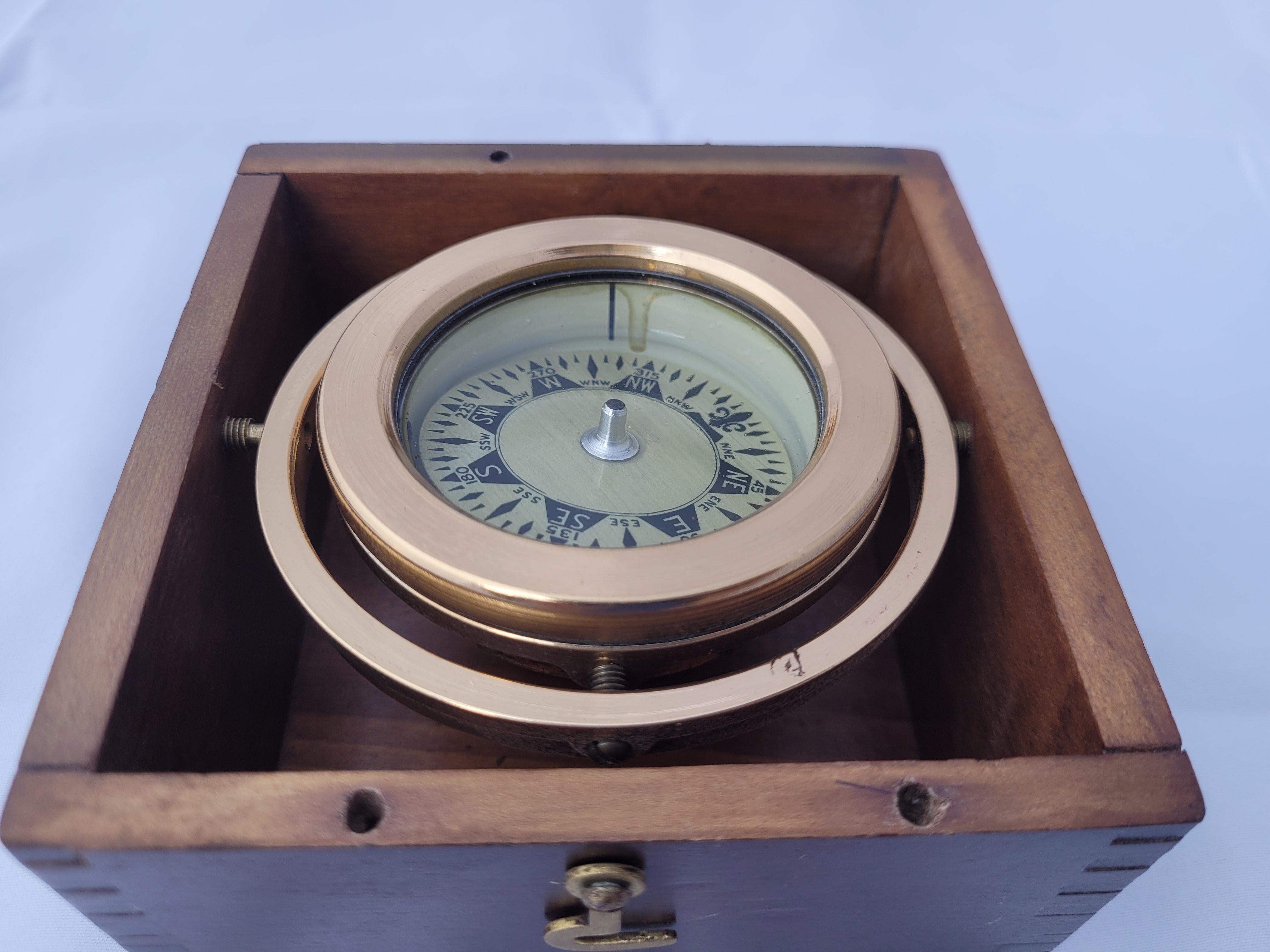 brass compass in wooden box
