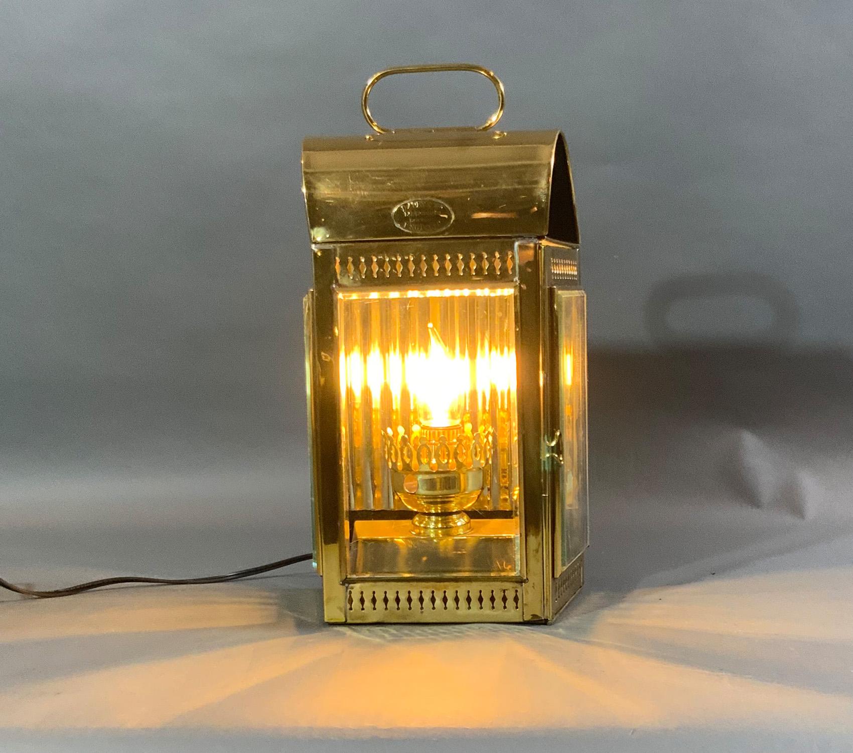 Brass yacht cabin lantern with highly polished finish. Three glass panes and one hinged door. The oil tank has been fitted with an electric socket recently wired for home use. Very nice condition.

Weight: 6 LBS
Overall Dimensions: 14” H x 9