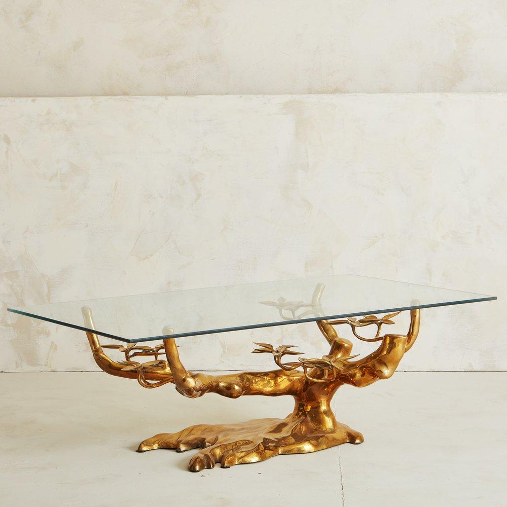 This stunning vintage brass coffee table features an intricate base in the shape of a bonsai tree and a thick, faceted glass top. Belgium, 1970s.

Willy Daro is a French Postwar artist known for his botanical and floral sculptural forms, as well