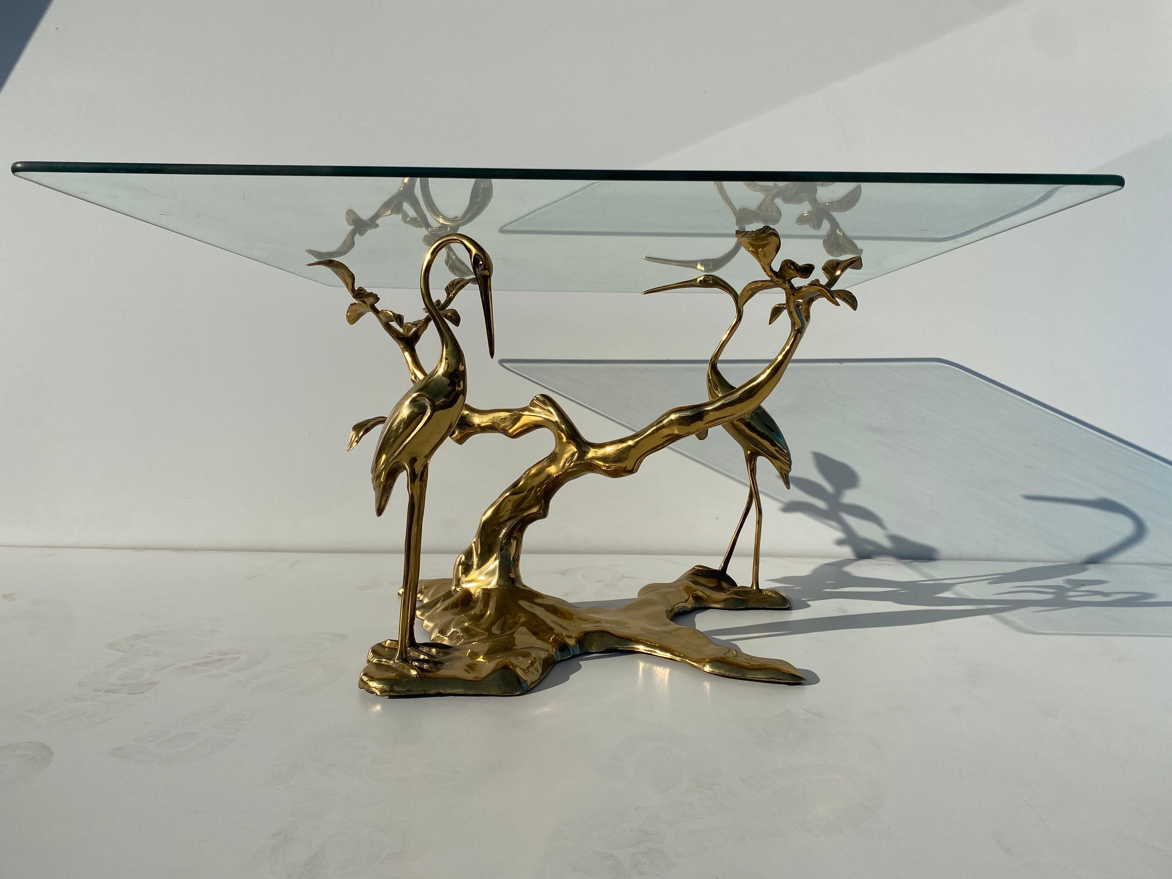 Brass bonsai tree and cranes coffee / side table in the manner of Willy Daro. Glass shown is 33” x 33” by 3/8” thick and not included. Table base will hold larger and heavier glass top in round or rectangular shape. We have two tables available.