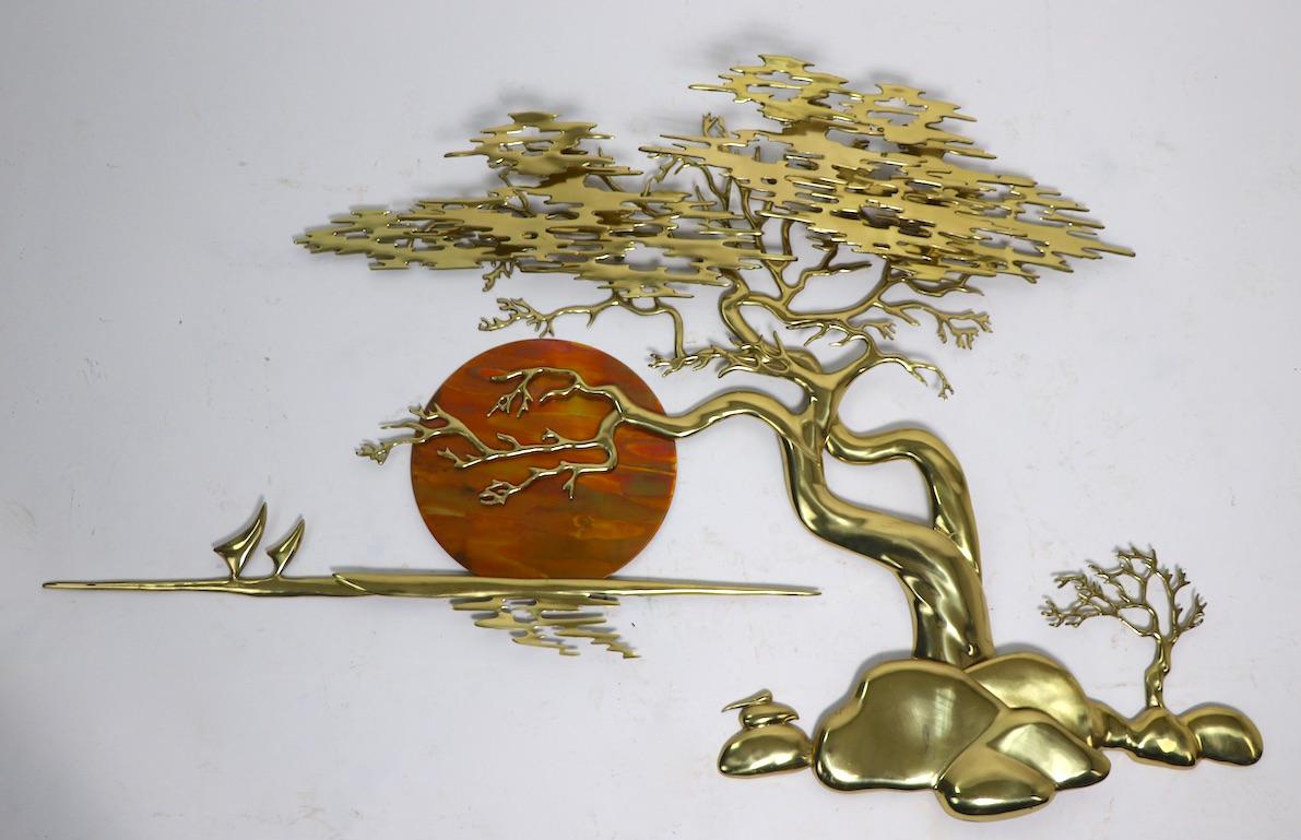 Impressive brass wall hanging sculpture signed Bijan 85. The sculpture depicts a bonsai tree with colorful moon, or sun, on the background. This example is in very fine, original condition, clean and ready to install.