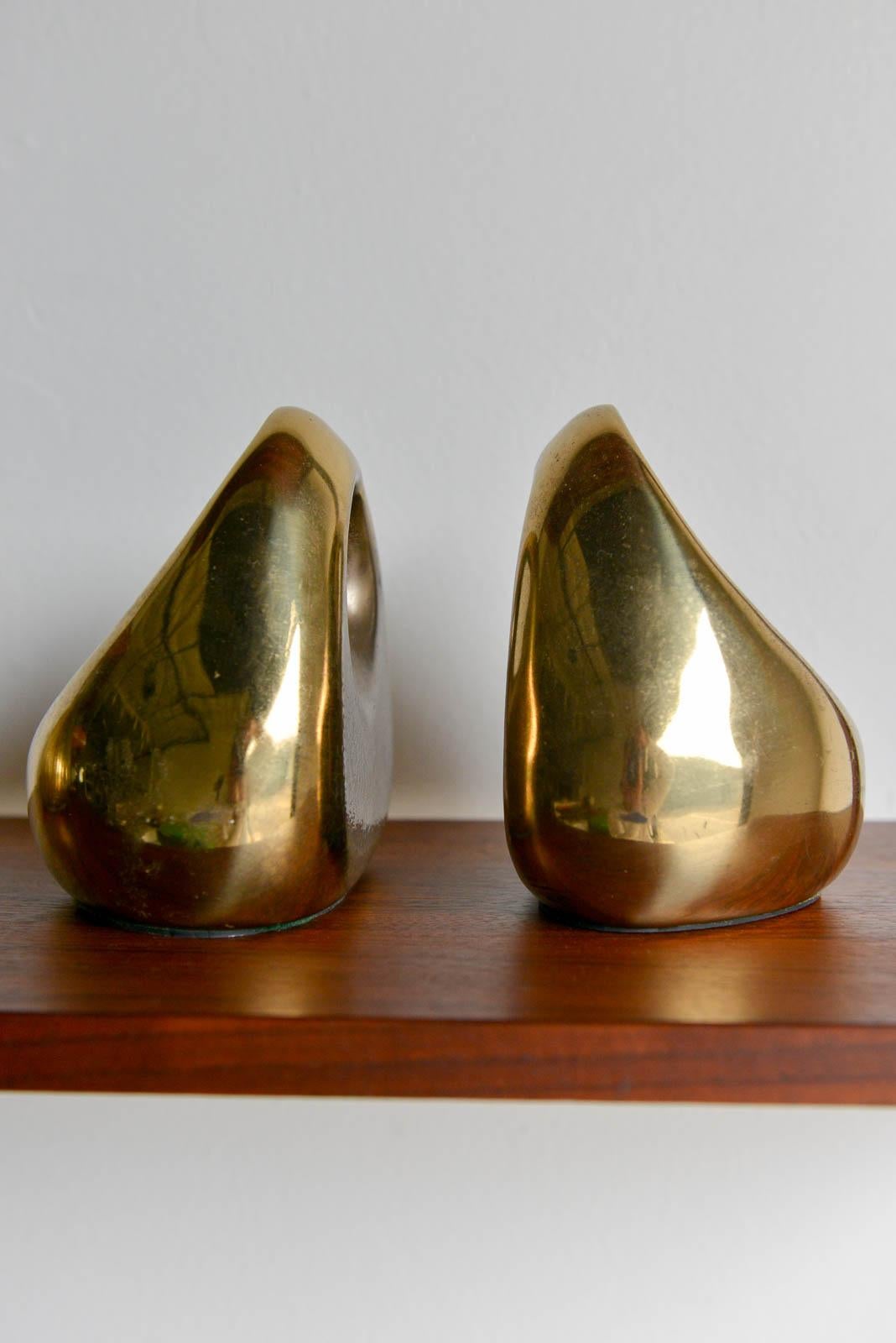 Brass bookends by Ben Seibel for Jenfred Ware, ca. 1960. Brass finish is vintage with some patina. Bottoms are felt lined to protect shelving.

Measures 
Height: 6 in. (15.24 cm)
Width: 5.5 in. (13.97 cm)
Depth: 4.25 in. (10.8 cm).