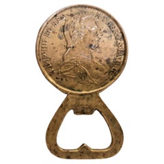 Brass bottle opener featuring a Maria Theresa thaler