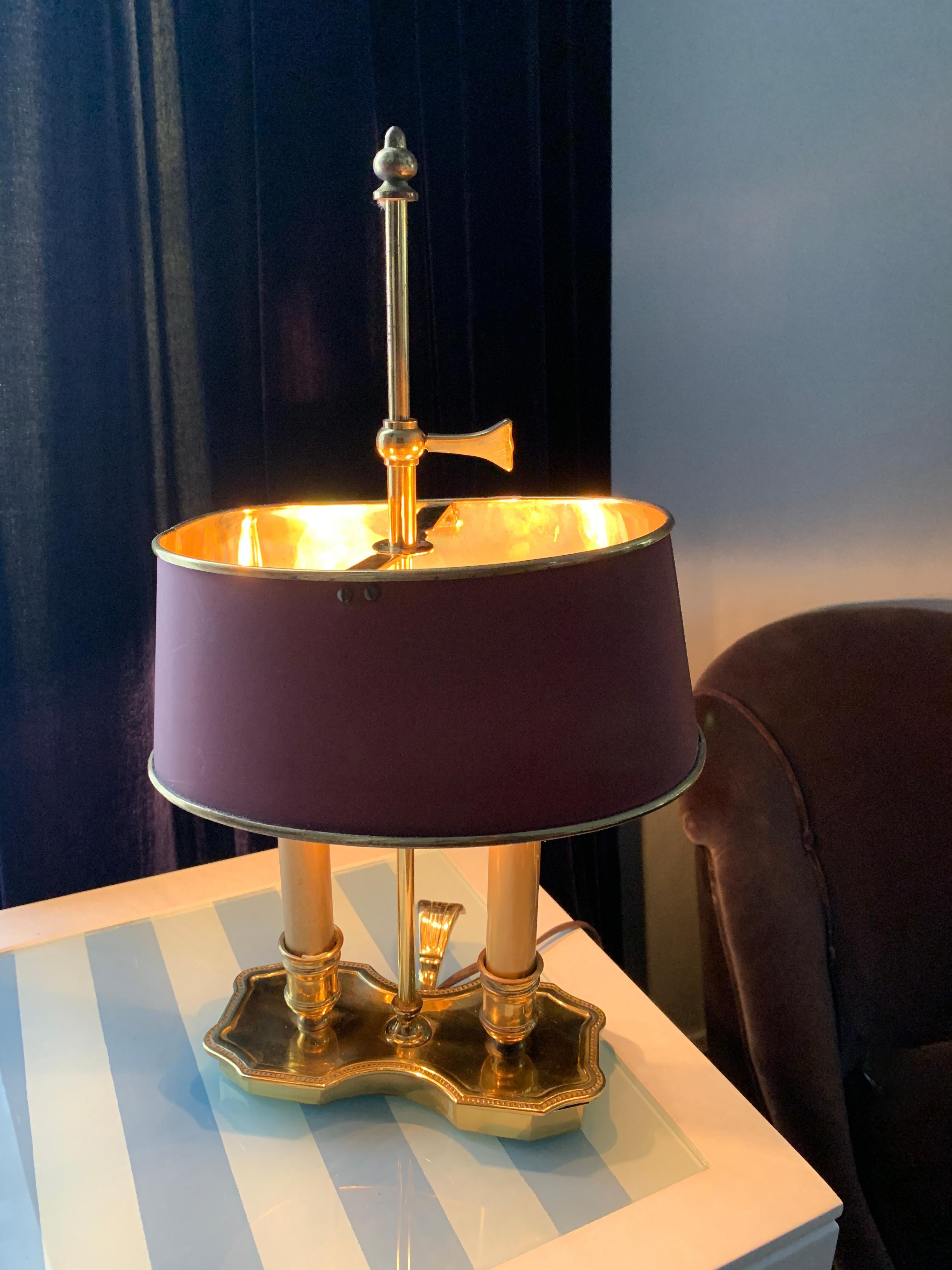 Double candle Bouillotte lamp with oval tole shade. Perfect for a desk or any area where good light is needed without having a large lamp. The shade is metal with a polished brass inside for beautiful reflection, and the base has a wonderful thumb