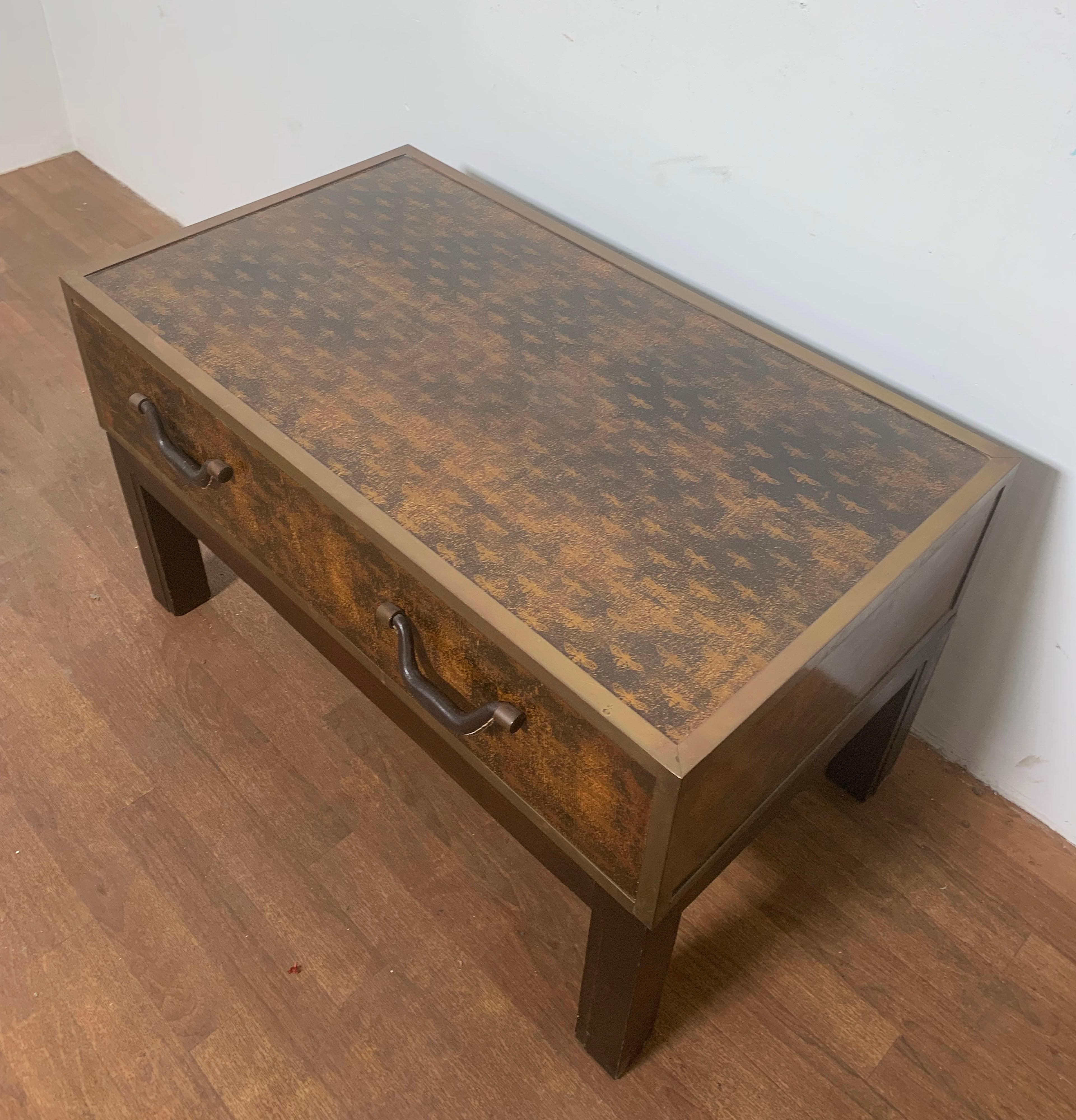 Campaign style brass bound chest on stand, clad in “Napoleonic Bee” parchment, with single drawer and leather handles, circa 1970s. Functions as a coffee or occasional table as well.