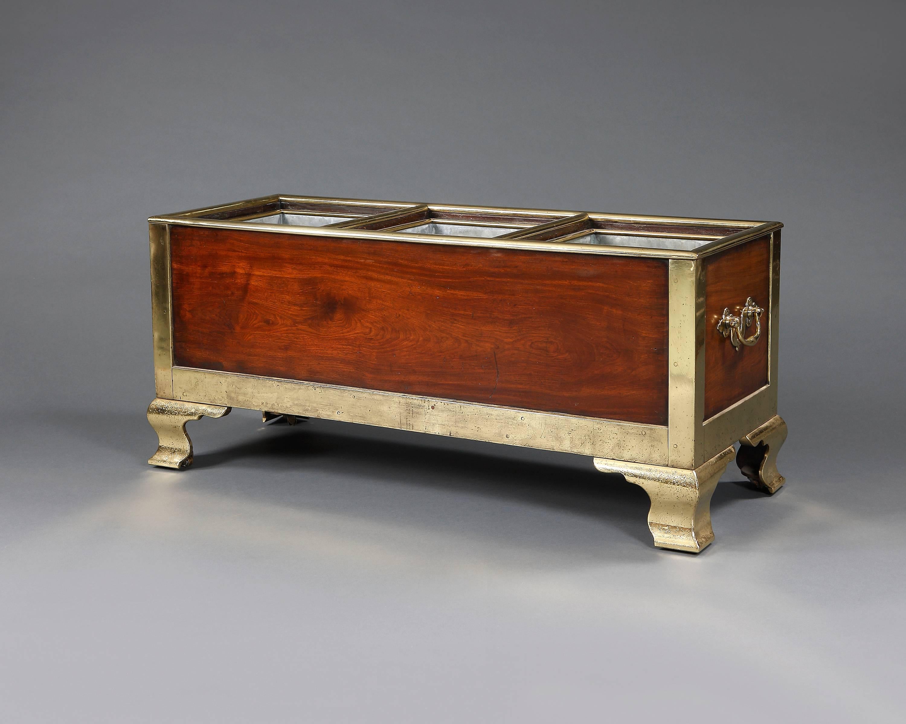 A magnificent mahogany brass bound planter or wine cooler with three divisions. The three liners and shaped bracket feet are later replacements, English, circa 1775.