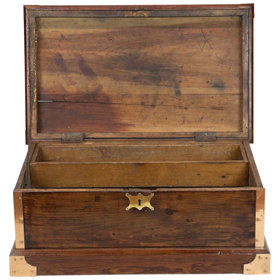 Brass bound sea chest has the original brass carrying handles. The camphor wood top has an attached quatrefoil molded camphor panel, the rest of the chest is pine, all corners and edges with applied brass fittings. There is an interior removable