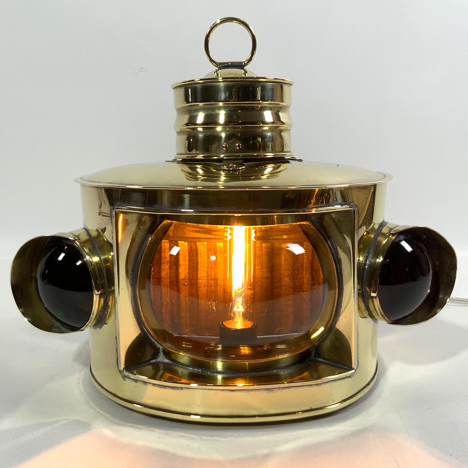 Highly polished brass yacht lantern with clear masthead lens and res and green bullseye glass port and starboard lenses. Hinged door to rear that has a seahorse badge attached. Vented top. Wired for home use. Large in size, very fine. Hard to find