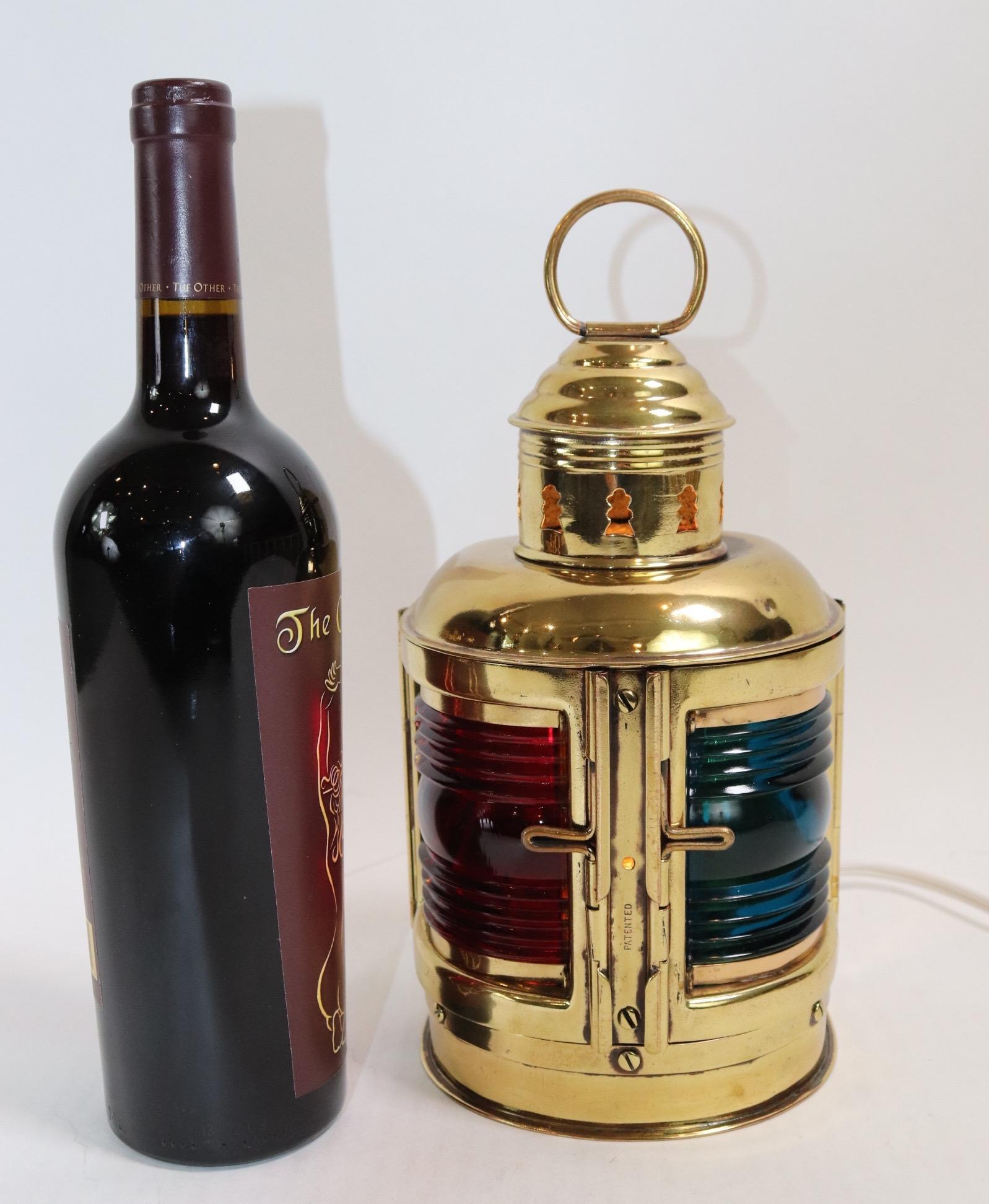 Solid brass port and starboard boat lantern by Perko. The red port lantern has a vertical crack. Lantern is mounted to a wood base and is electrified for home display. Weight is 4 pounds.