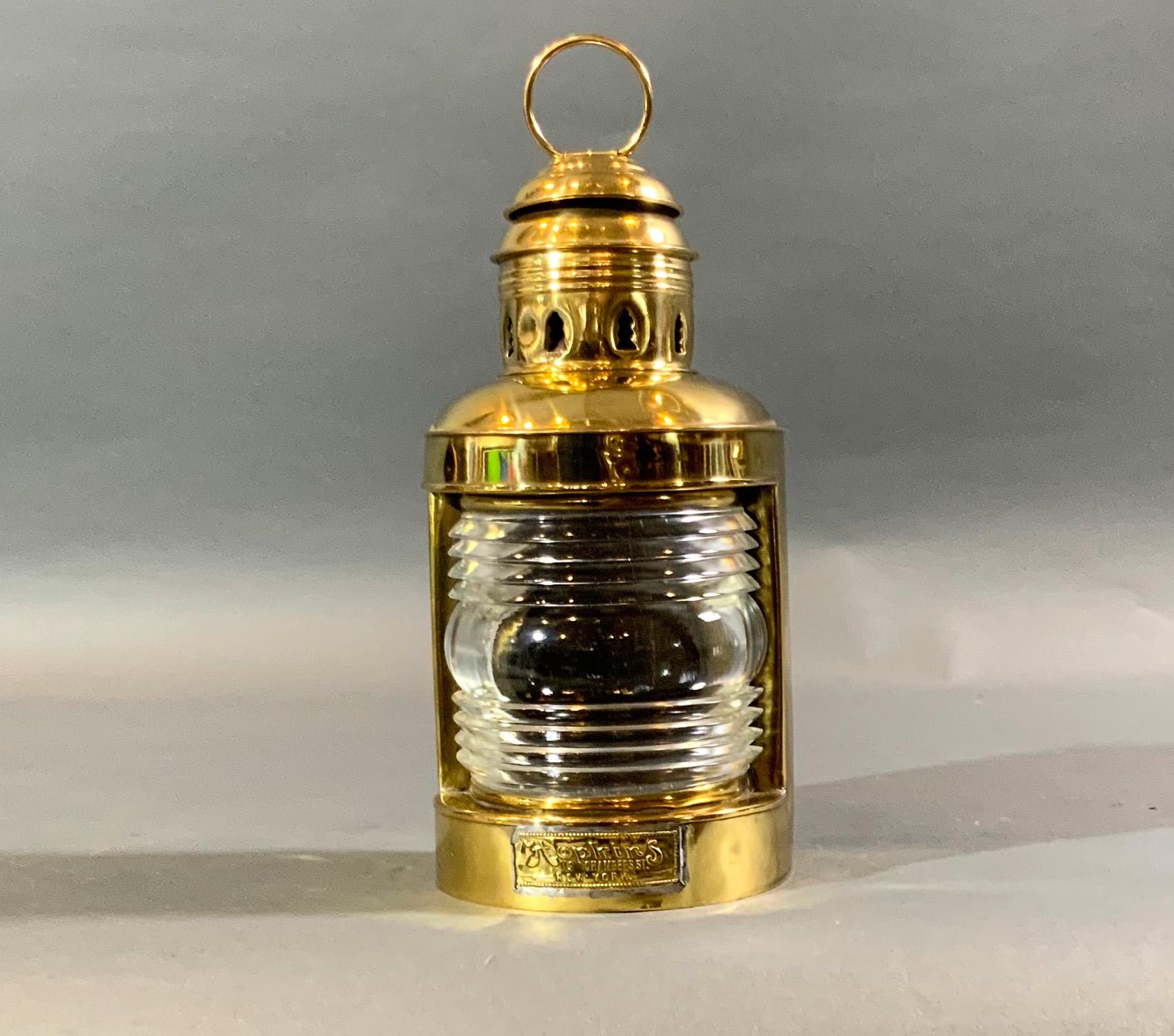Solid brass ships masthead lantern with makers label from Hopkins of 119 Chambers St New York. With Fresnel glass lens. No burner.

Weight: 2 LBS
Overall dimensions: 11” H x 6
