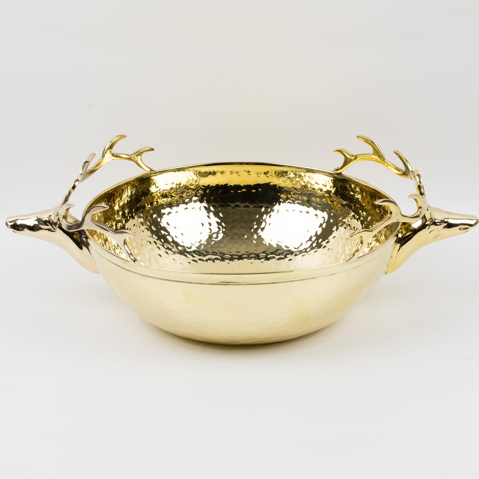 This elegant Italian 1980s polished brass decorative bowl or centerpiece features an important dimensional shape with a lightly hammered texture inside and out, and two large stag heads serve as handles. There is no visible maker's mark.
The
