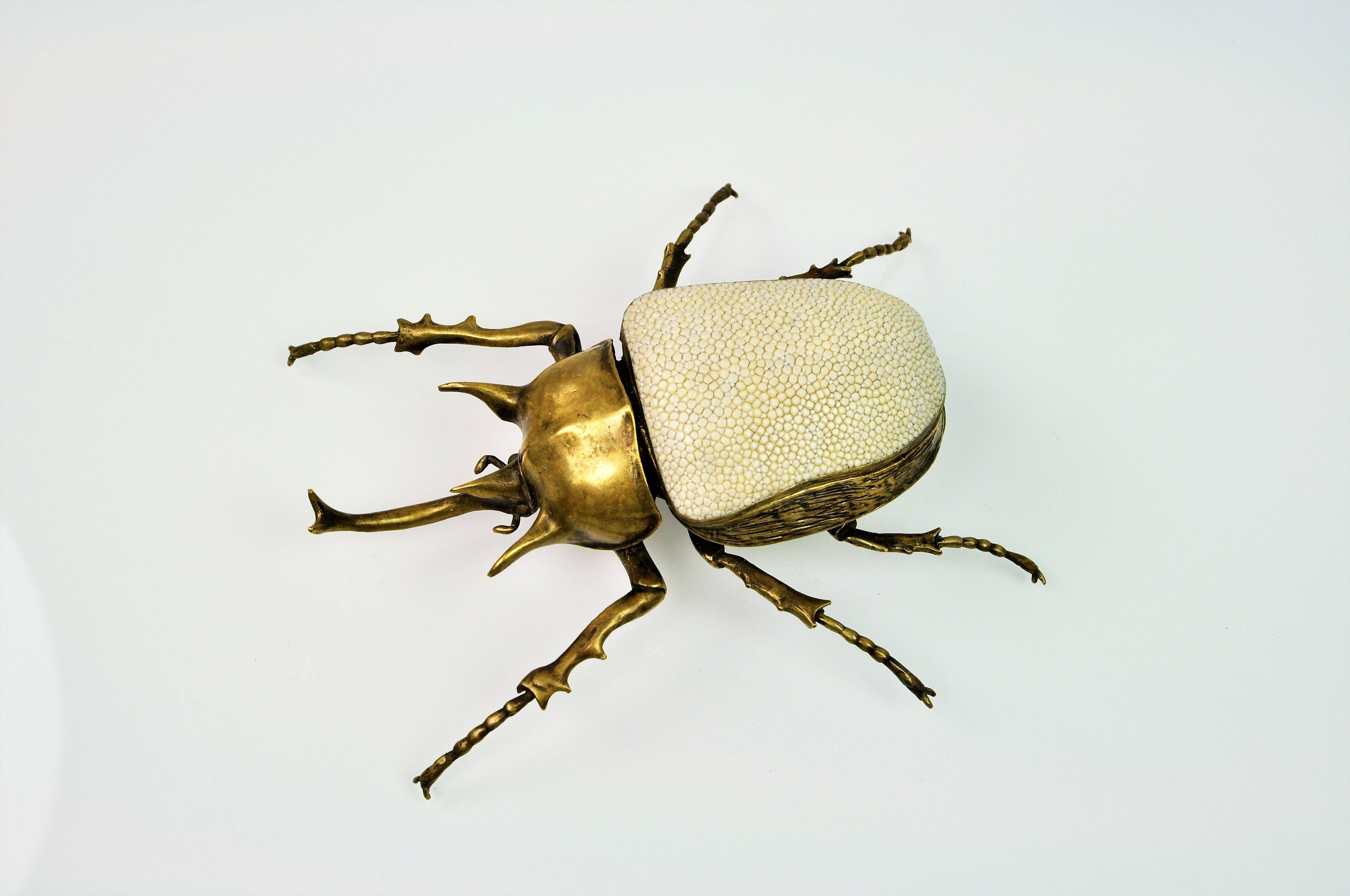 The Goliath Scarab box is a best seller at Ginger Brown
This piece is made in lost wax cast brass with a bronze patina. The brass lid is covered with shagreen.

That box has been realized from a real scarab. The famous Megasoma actaeon from the