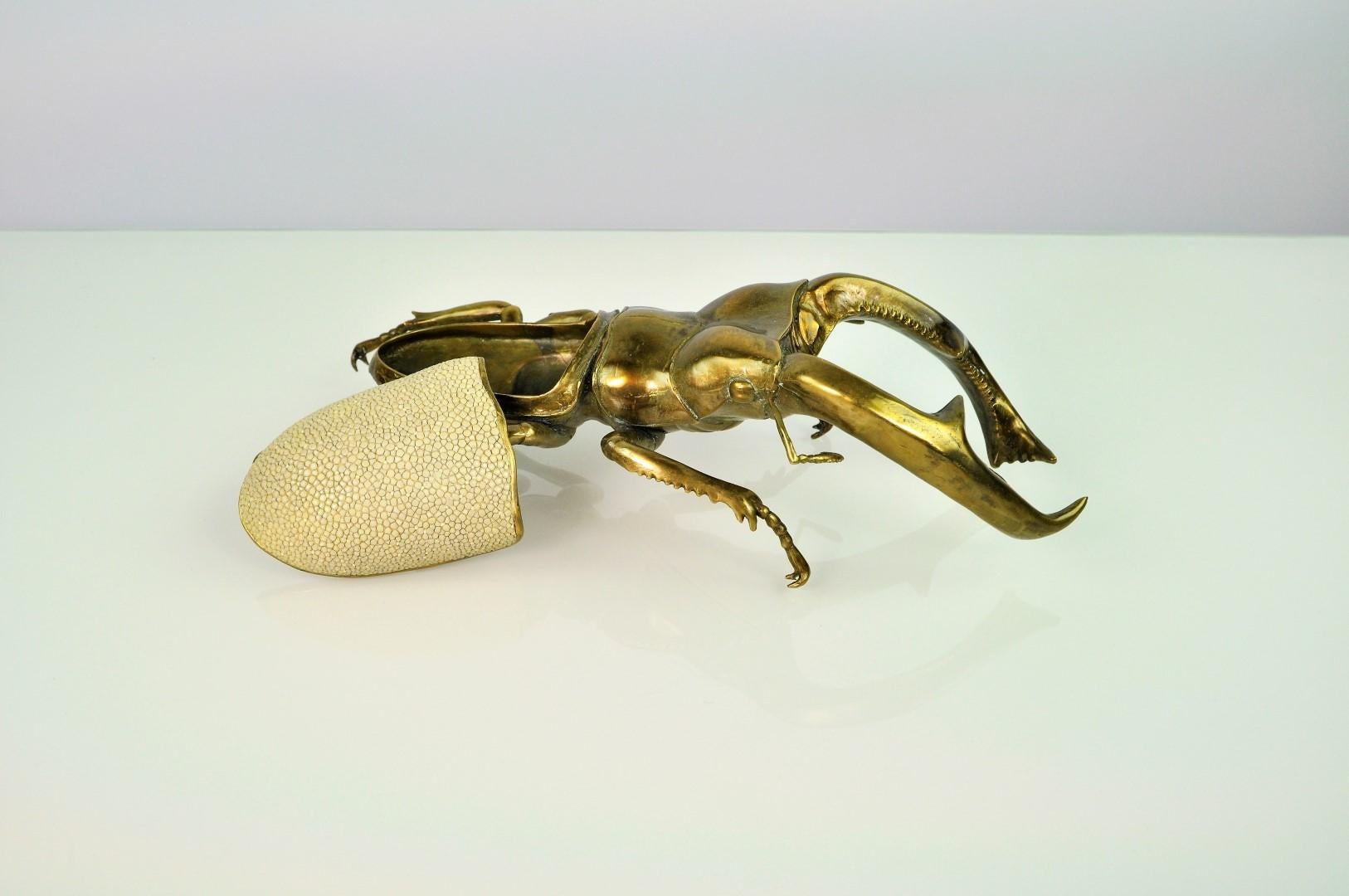 The Mandibularis Scarab box is a best seller at Ginger Brown
This piece is made in lost wax cast brass with a bronze patina. The brass lid is covered in shagreen.

That box has been realized from a real scarab. The famous Hexarthrius mandibularis