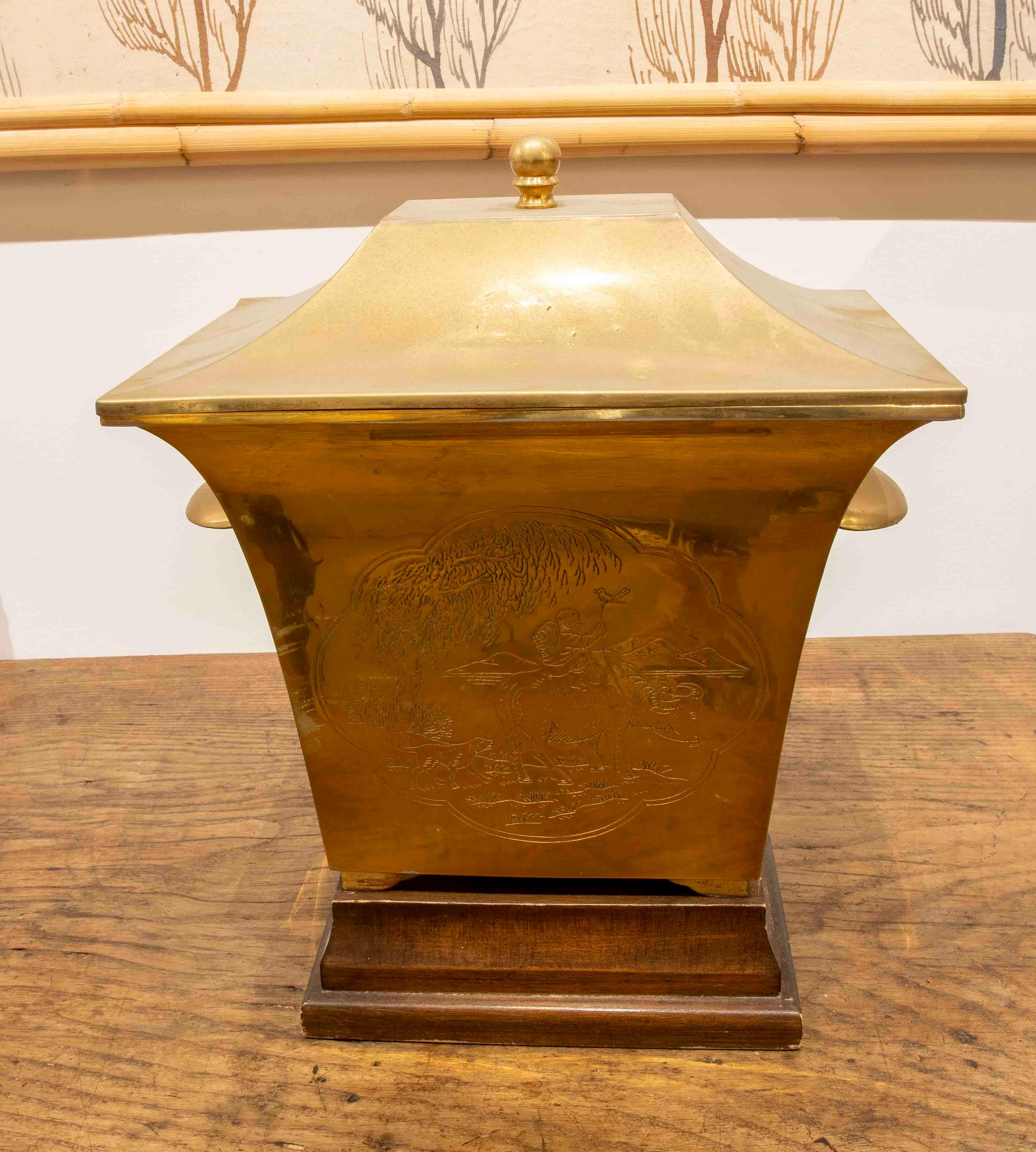 Asian Brass Box with Lid and Handles, Wooden Base and Embossed Decoration on Sides For Sale