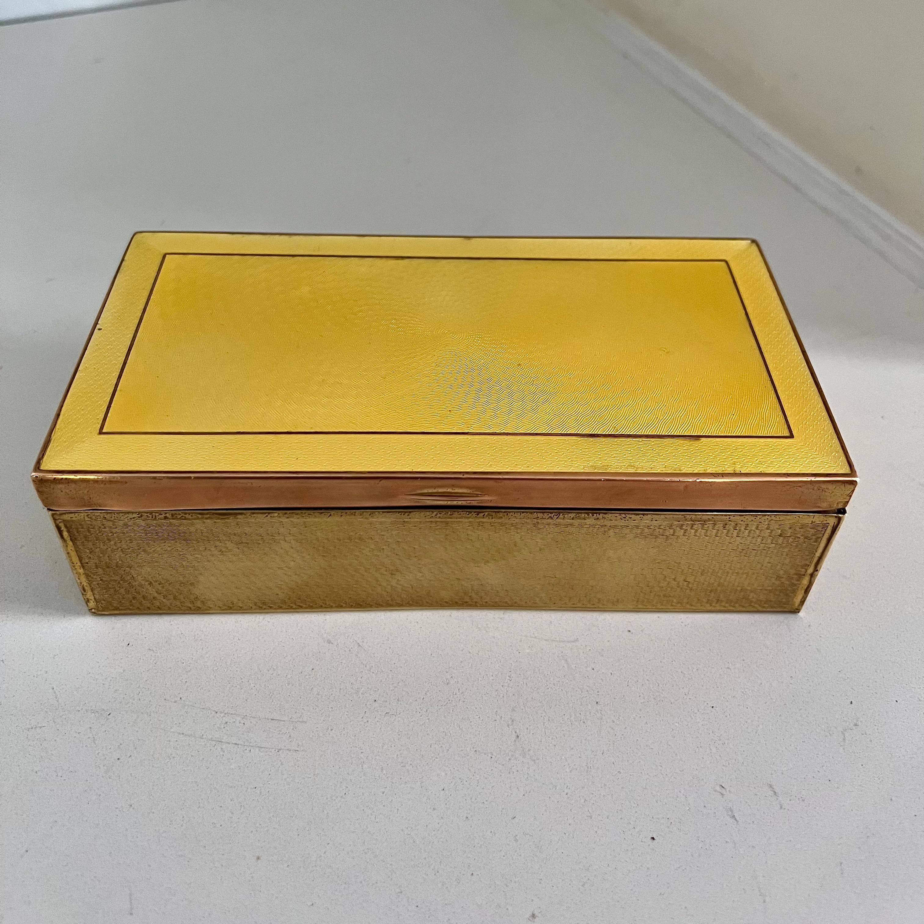 Hypnotic patinated Patterned brass with yellow guilloche enamel lid... This piece looks great bedside, on bookshelves and side tables, or perhaps the vanity. 

Wood lining and a well-oiled hinge. Be sure to watch the video to catch all the