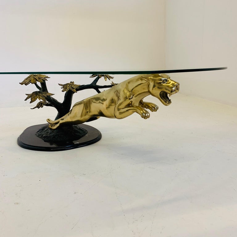 Very rare and decorative sculptural coffee table. Brass panther jumping from a bronze and brass tree on a marble stand. Attributed to Maison Jansen and made in the 1970s.
 