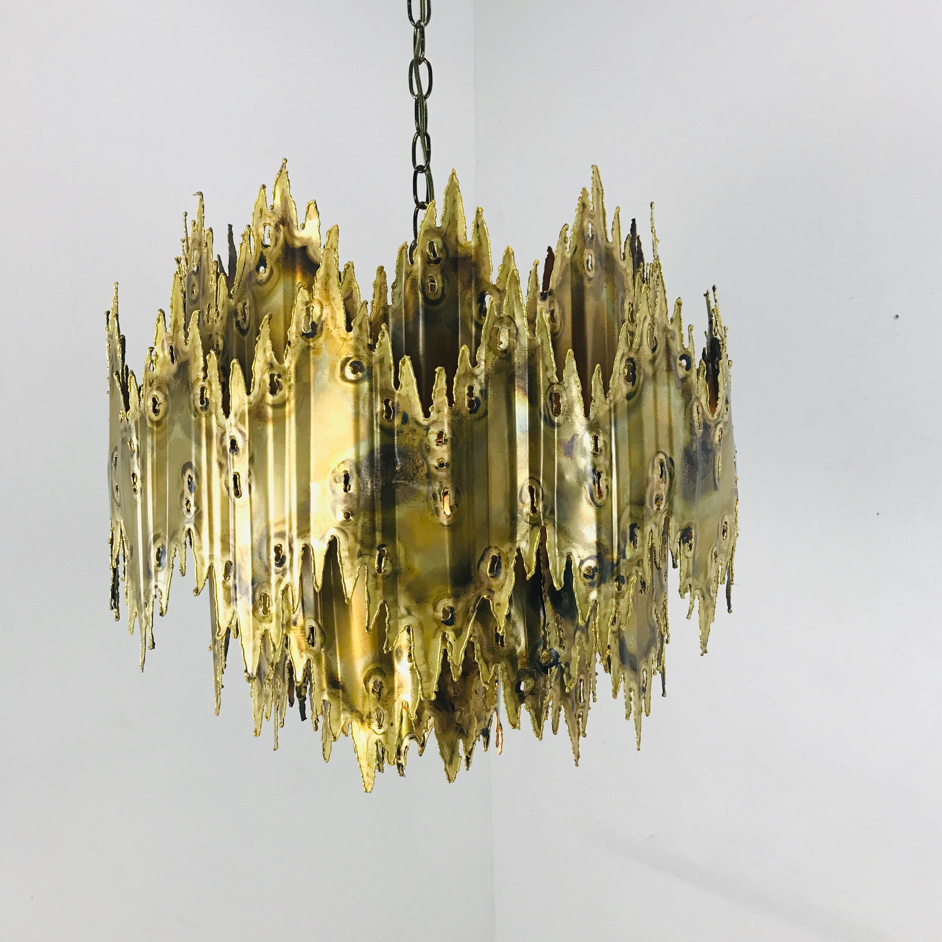 Torch cut and patinated brass chandelier by Tom Greene for Feldman.