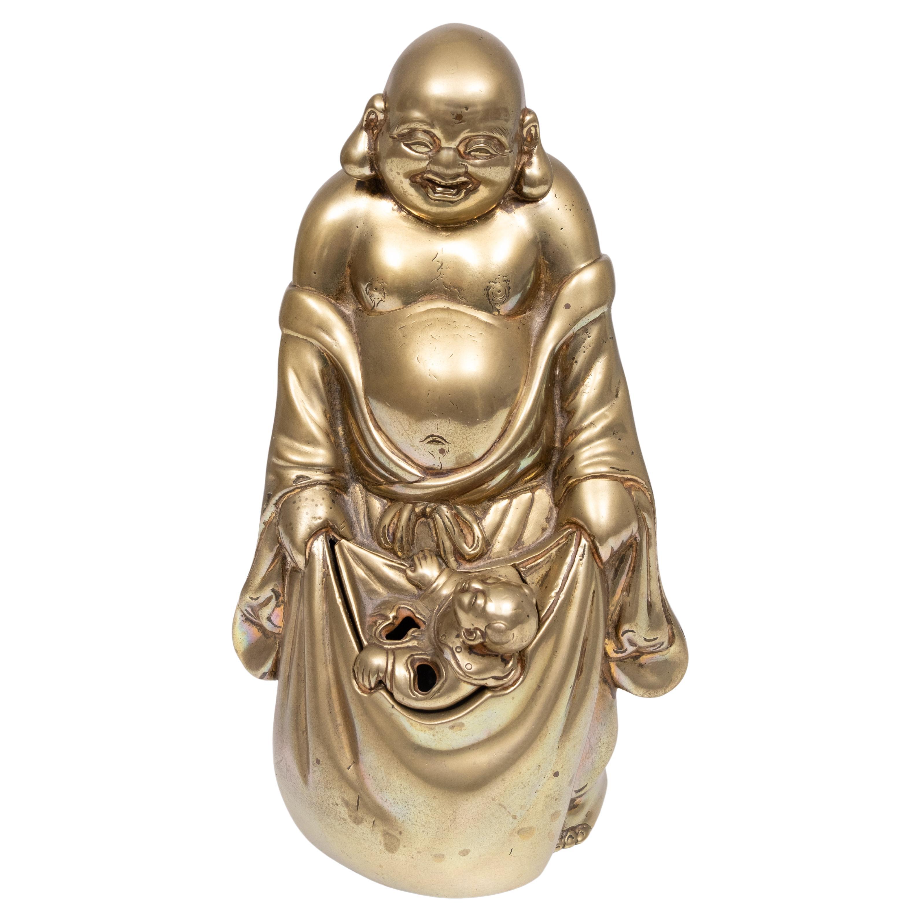 Chinese Buddha with child . The child is a insert ,can be removed .
The holes are for incense ,i think . strange combination  .Do you 
now more than me . Solid Brass .