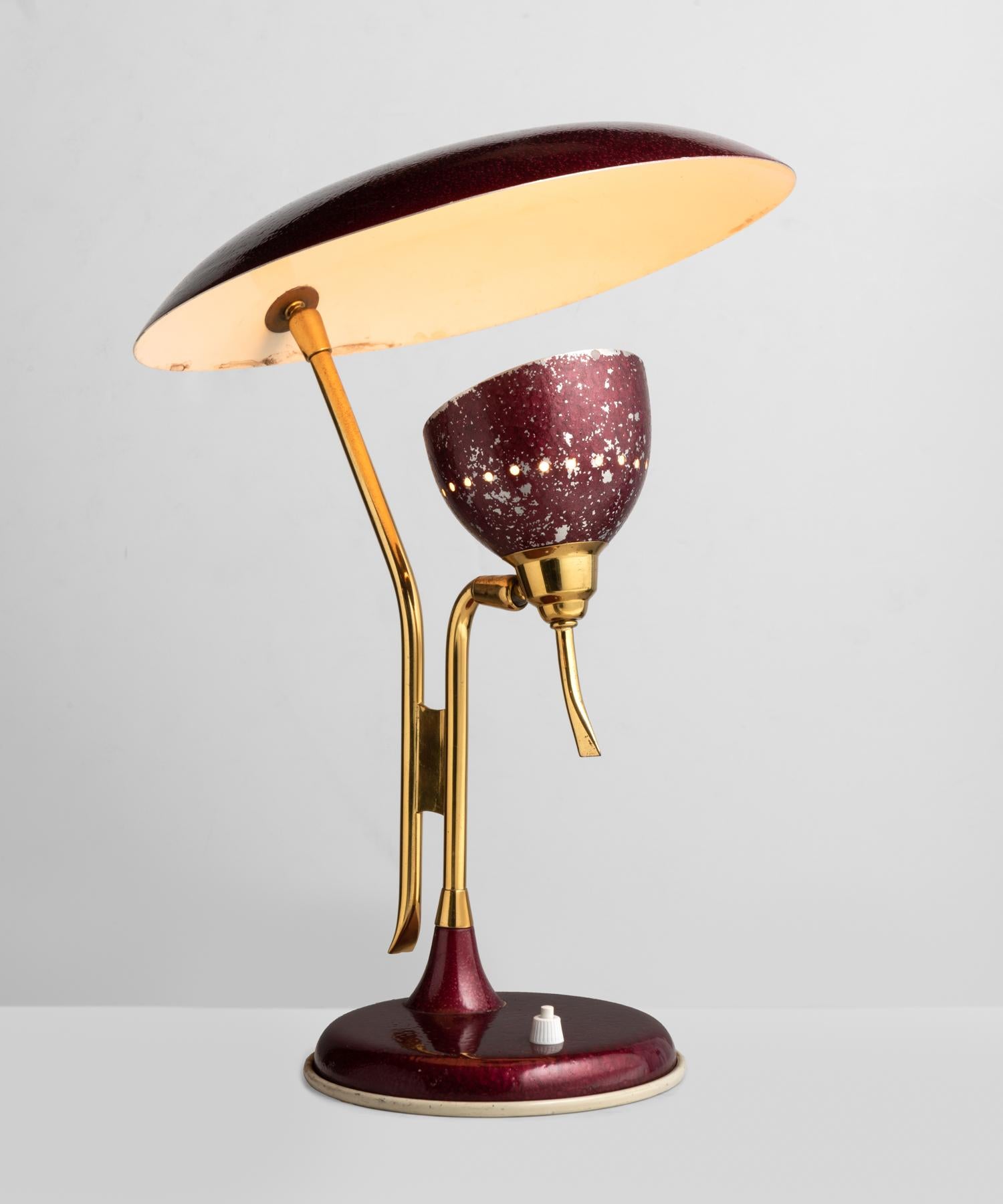 Brass & Burgundy table lamp, Italy, circa 1950.

Unique form in original, metallic burgundy paint includes two adjustable brass arms to individually adjust the shade and a larger reflective dish.