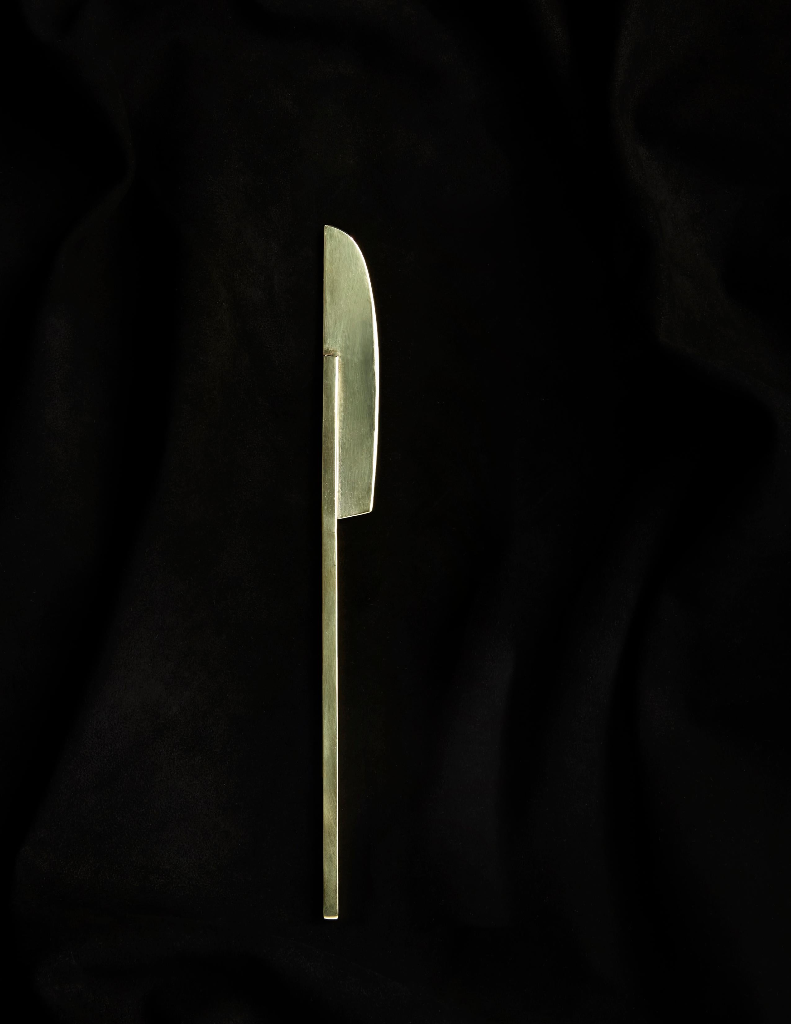 Add a touch of sophistication to your dining experience with this stunning butter knife, expertly crafted by Heath Wagoner at HW. Studio in Brooklyn, NY. The knife's flawless high-polish brass finish, coupled with its meticulous fabrication and