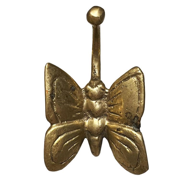 A small brass butterfly motif wall or door hook. It's all in the details, and this pretty brass vintage hook is the perfect way to add a touch of vintage style to any room. Use it to hang a robe, bathroom towel, or bag. 

Dimensions:
3.75