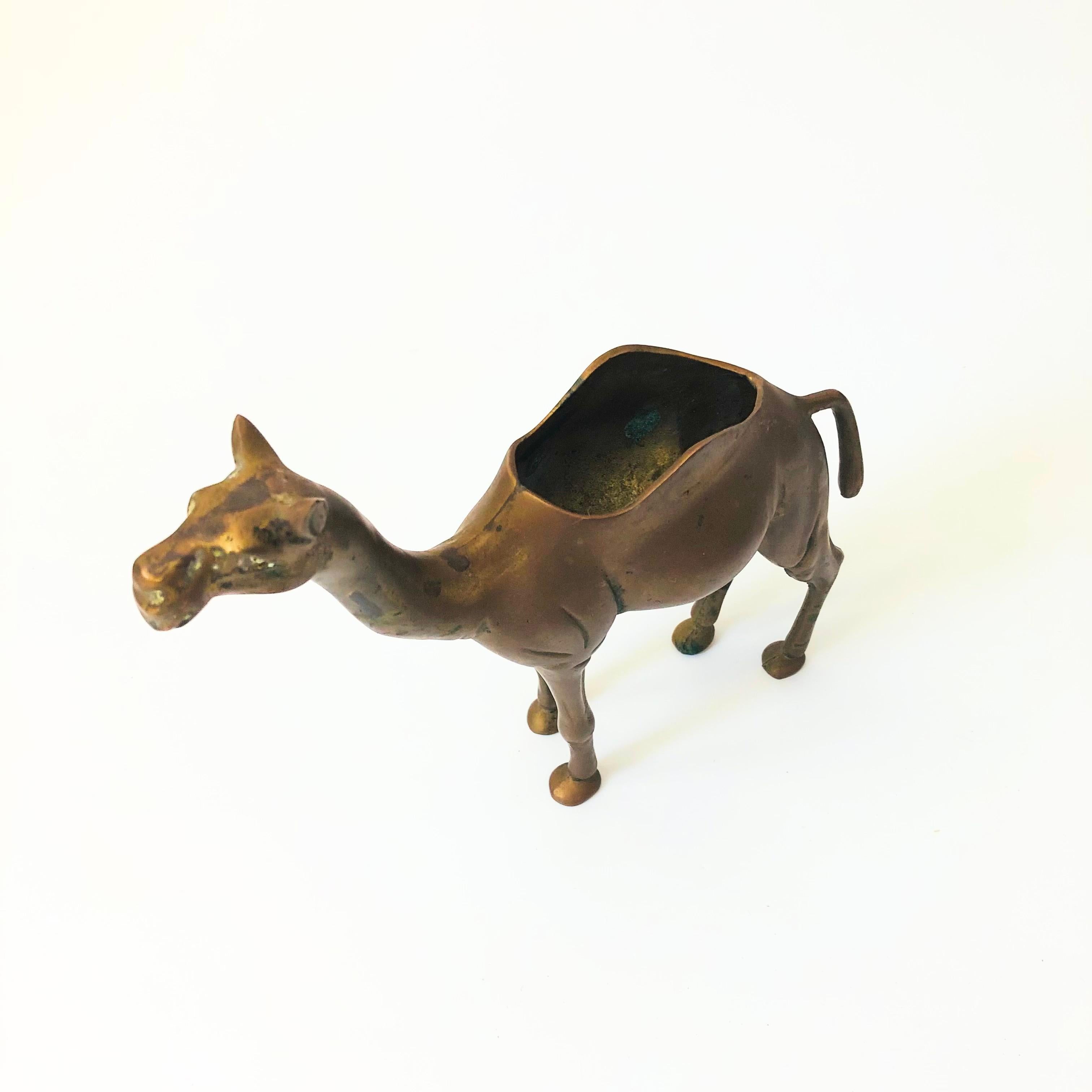 A vintage brass camel planter. Beautiful detailing formed into the brass with an open compartment in the camel's hump for using as a planter.

