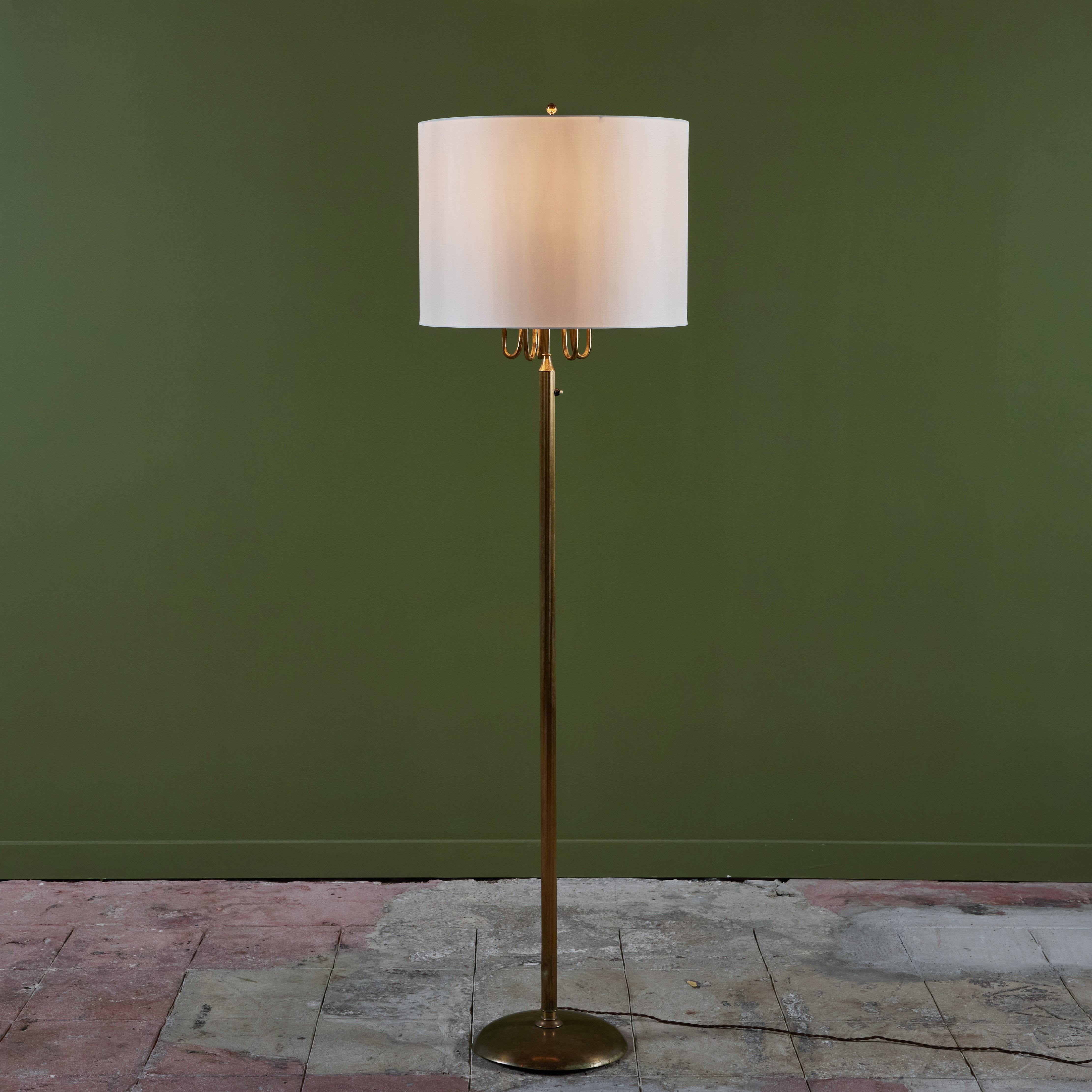 Brass floor lamp features a patinated bronze base and ribbed stem with new silk shade. The lamp has five curved arms under the lamp shade each with one bulb.

Dimensions
20